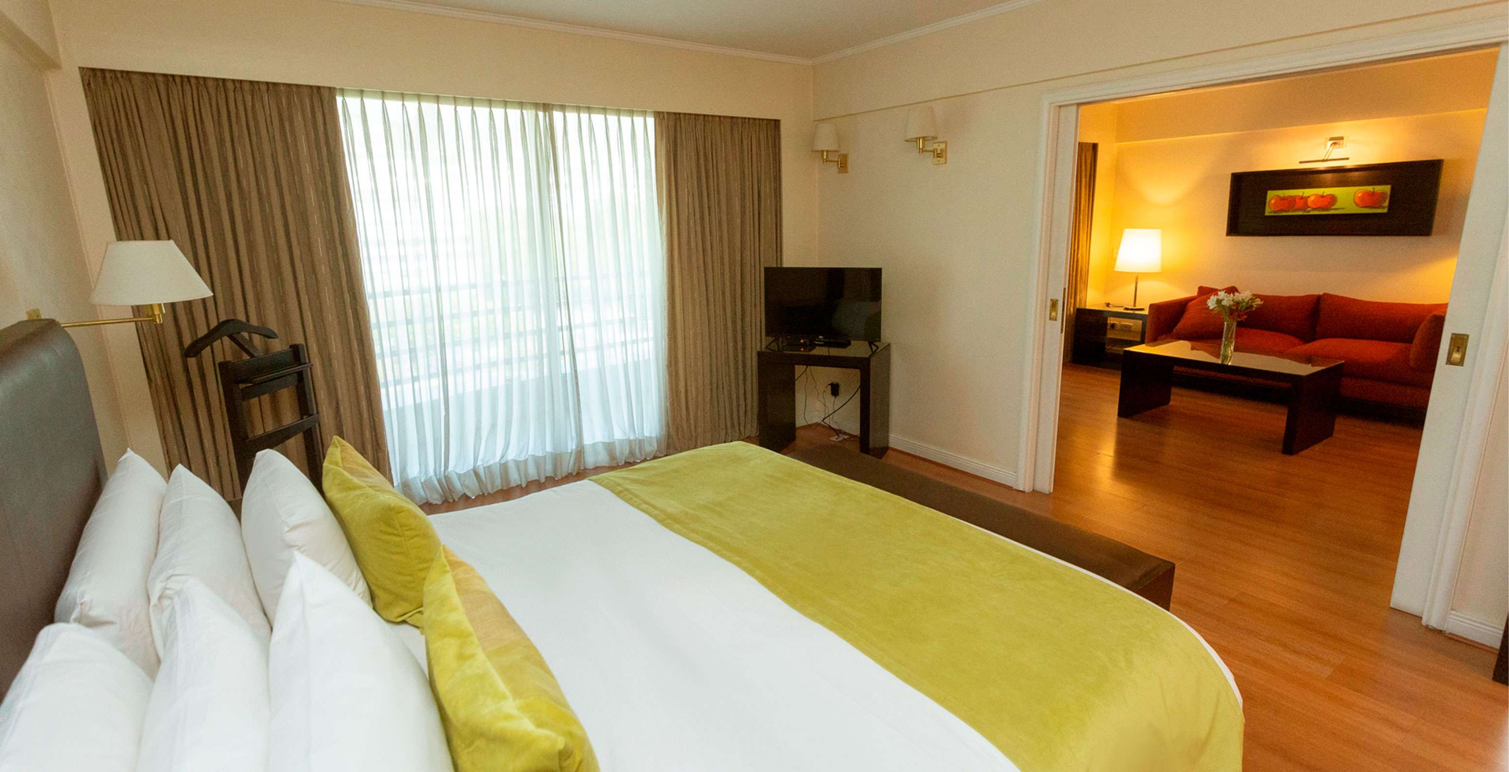 The Suite at Pestana Buenos Aires has a double bed, lamp, TV, and sofa