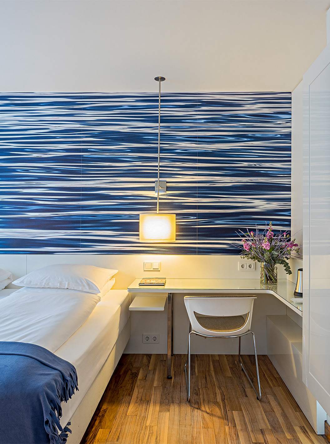 Deluxe Room with Terrace at Pestana Berlin Tiergarten has a double bed and a desk with lamp and chair