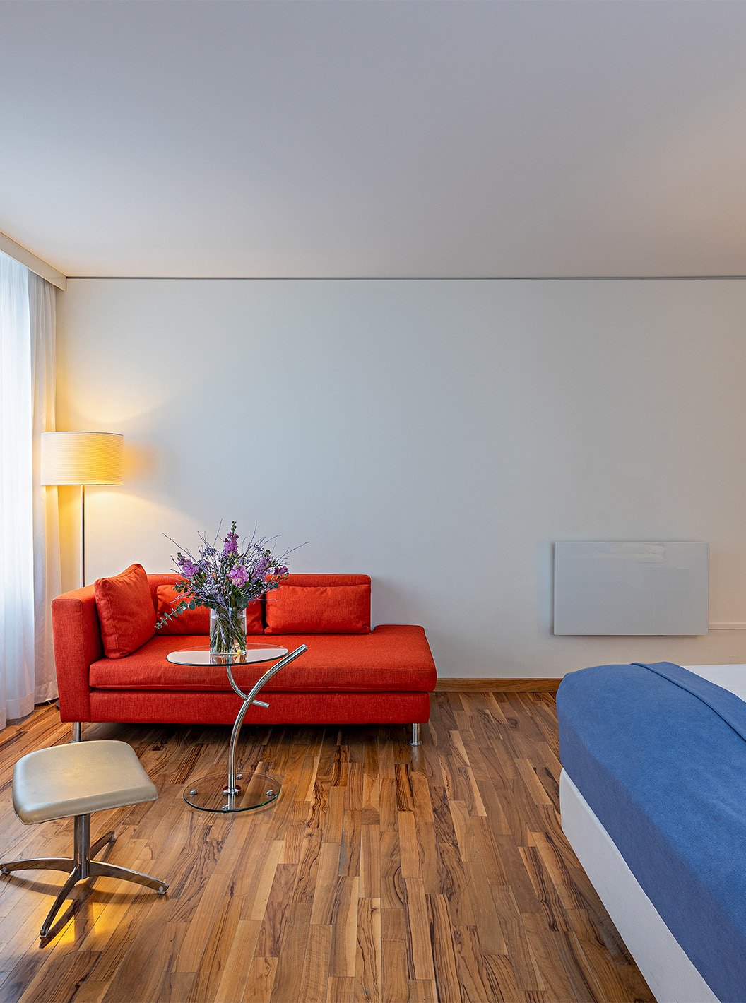 Grand Deluxe room at Pestana Berlin Tiergarten has a double bed, a sofa, coffee table, and an armchair