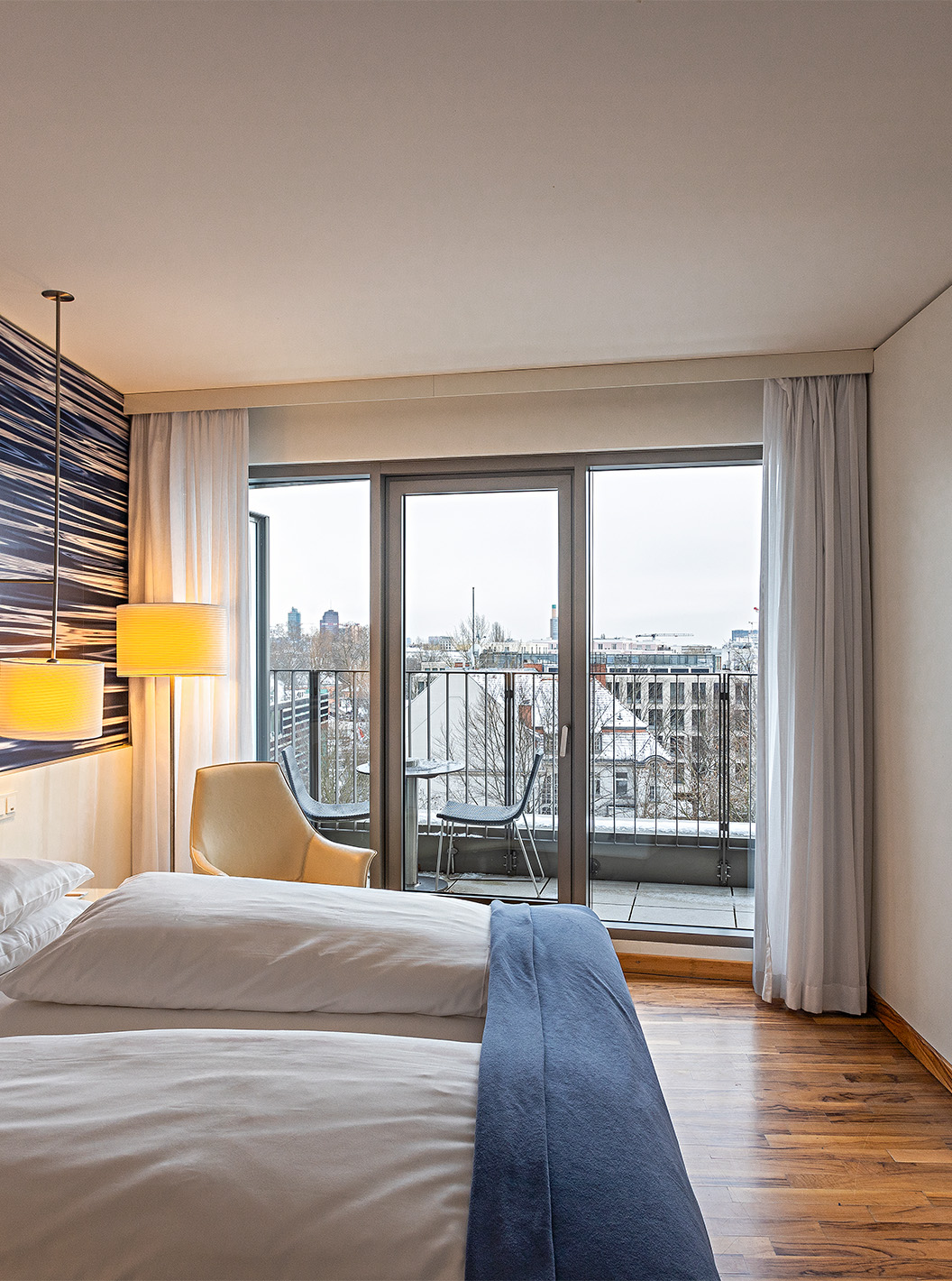 Premium Room with Balcony at Pestana Berlin Tiergarten has TV, balcony with city view, and an armchair