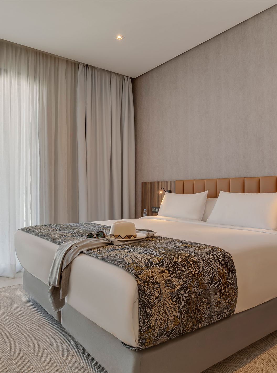 The Family Corniche Suite at Pestana Casablanca has a bedroom with a double bed and modern decor