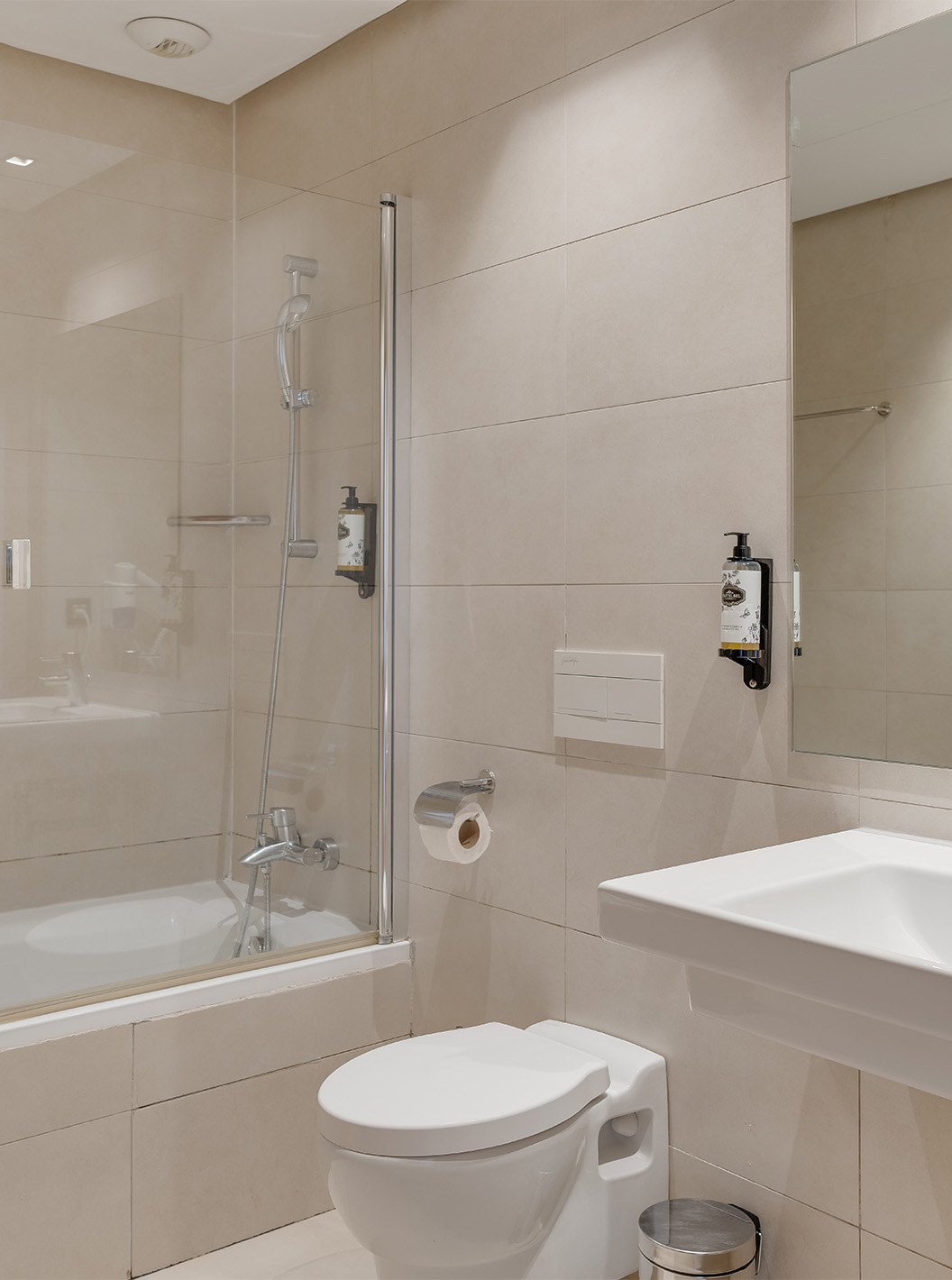 The Suite at Pestana Casablanca has a neutral-toned bathroom with a bathtub, toilet, and sink