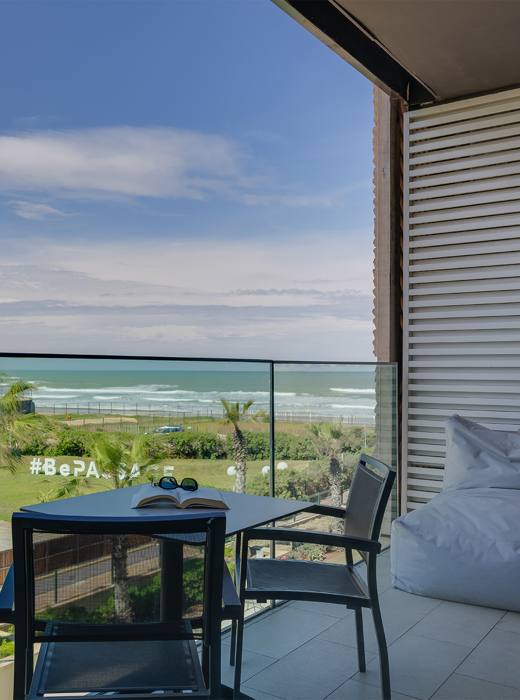 The Premium Superior Suite at Pestana Casablanca has an incredible balcony with a sea view, a table, and two chairs