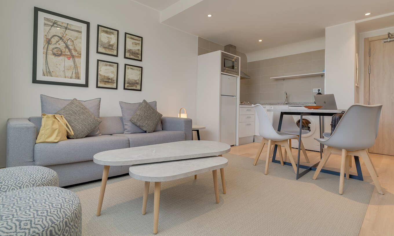 The Family Suite of Pestana Tanger City Center features a living room with sofa and a kitchenette with dining table