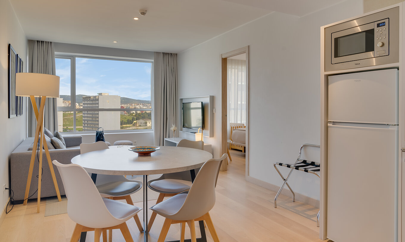 The Suite of Pestana Tanger City Center features a kitchen with refrigerator, microwave, and a dining table