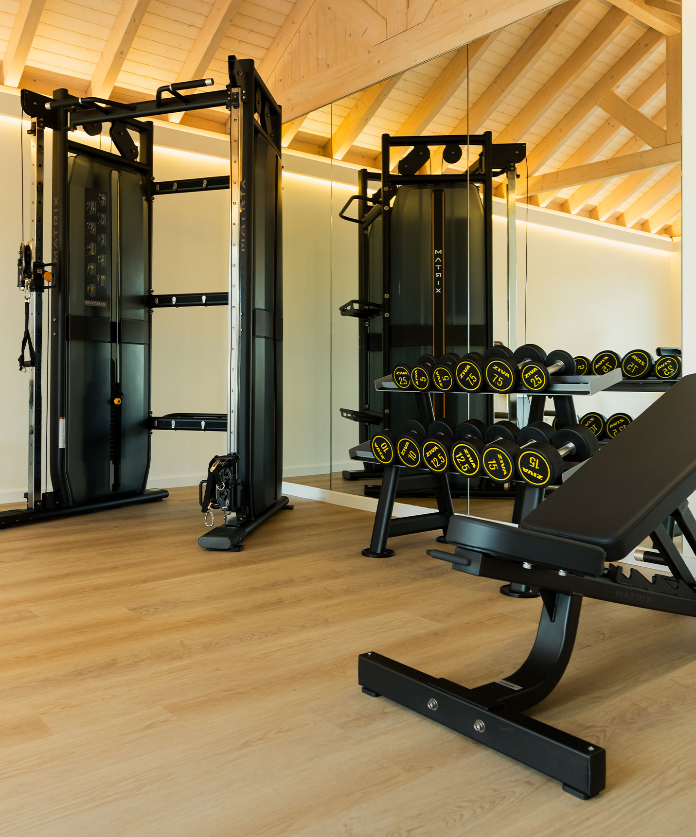 Gym equipped with a weight machine and dumbbells, located in the villas at Pestana Comporta Village Residences