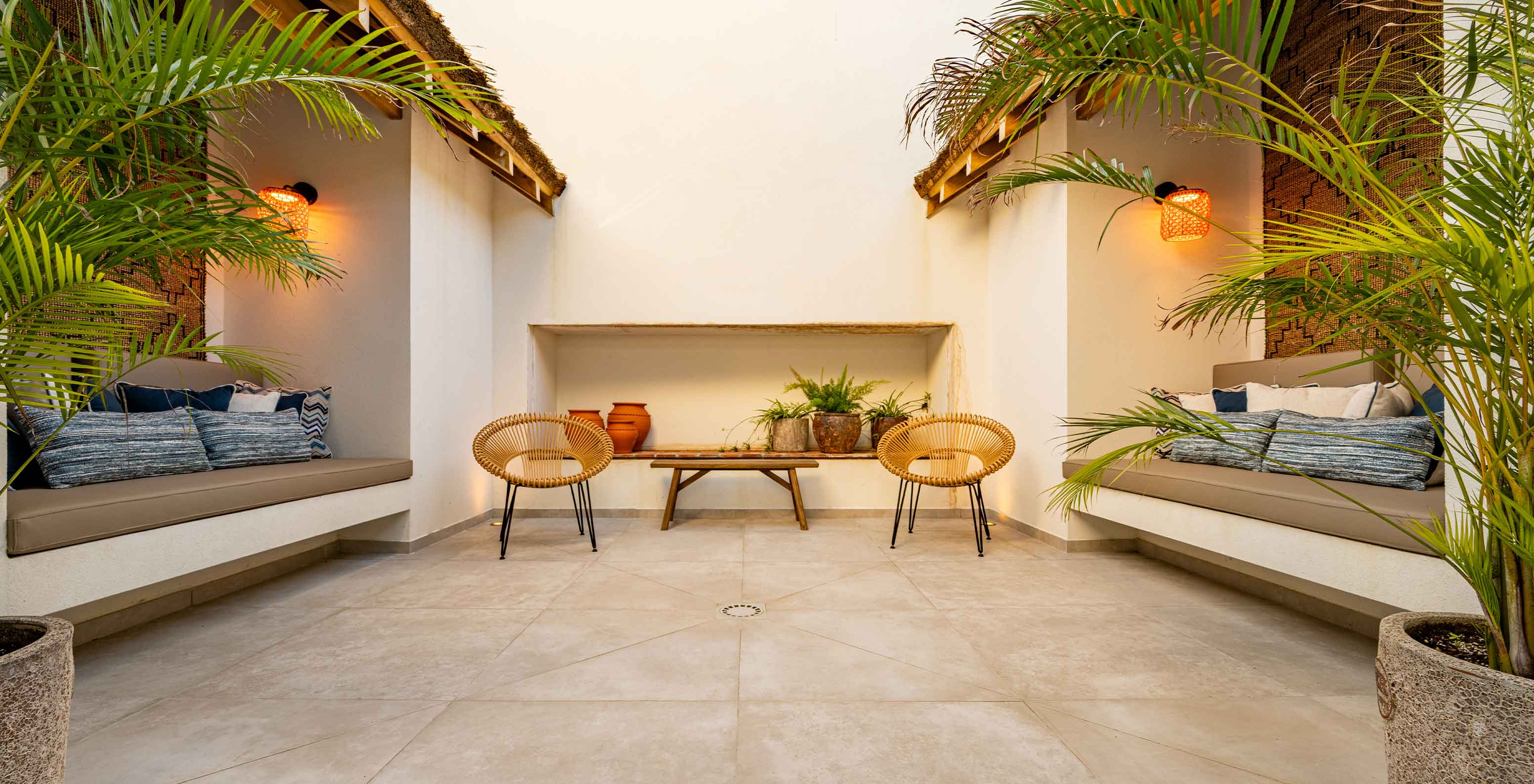 Outdoor seating area with benches, chairs, and greenery, at Pestana Comporta Village Residences