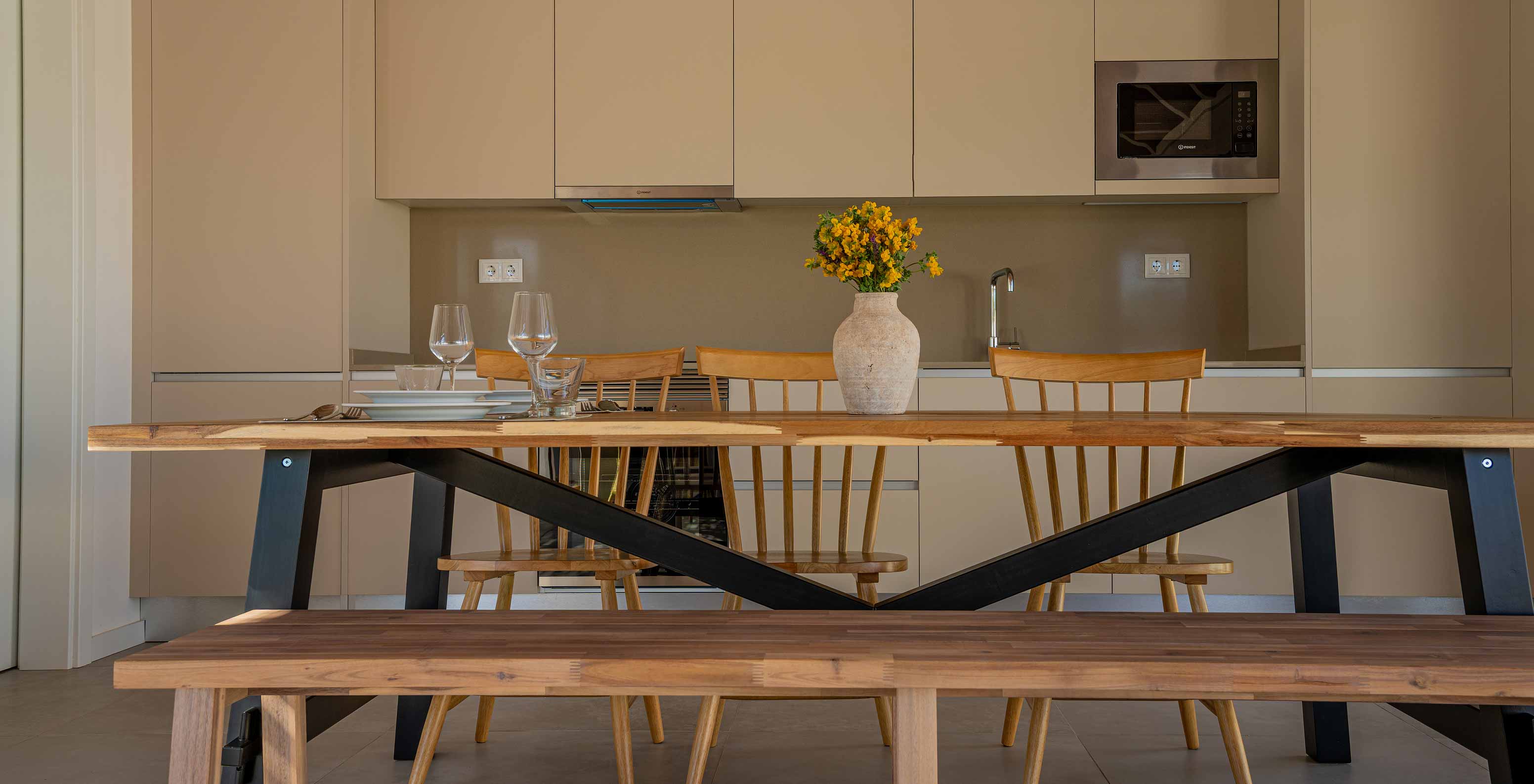 The Premium Villa at Pestana Comporta Village Residences has a modern kitchen with a wooden table and an oven