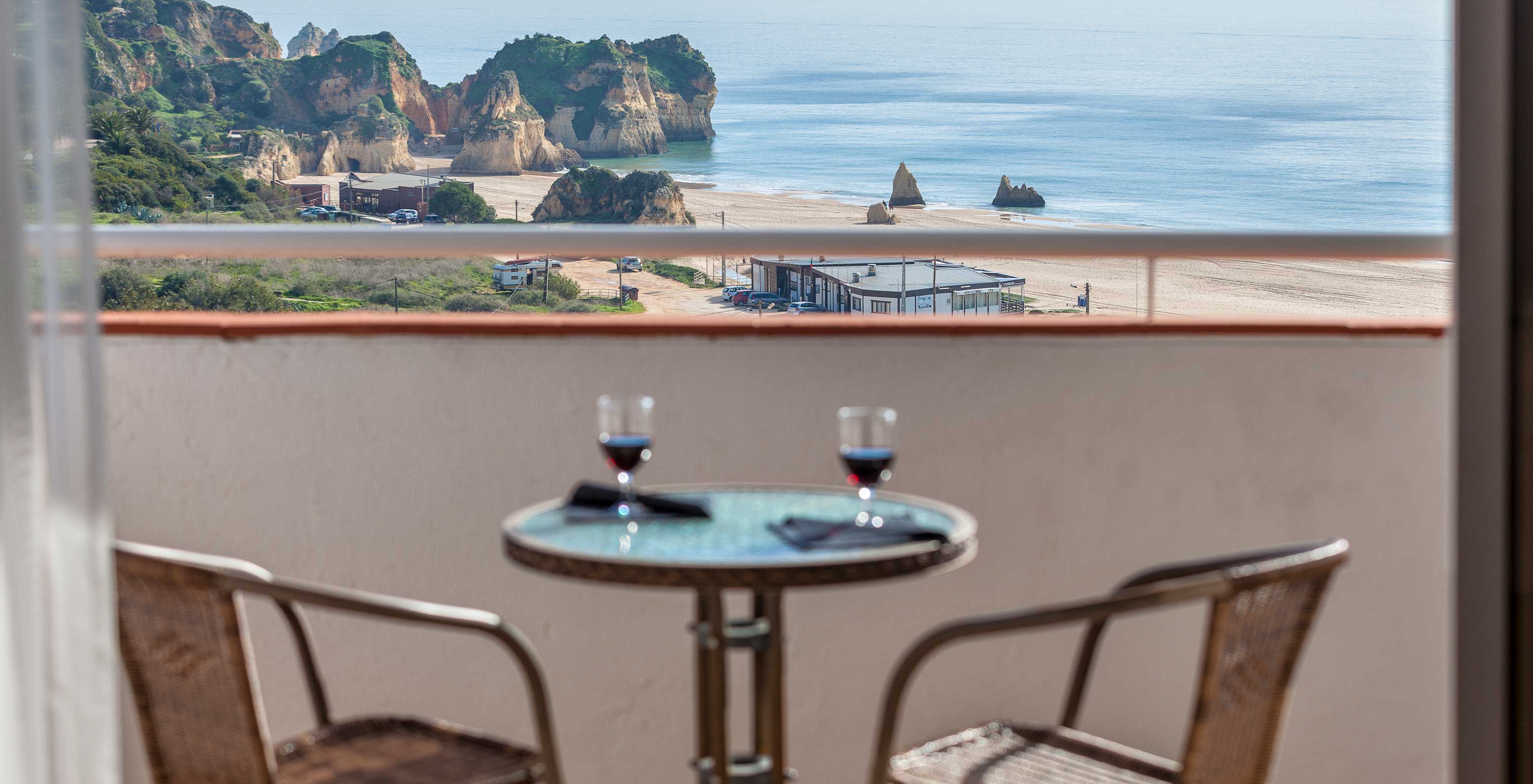 The T1 Sea View Apartment at Pestana Alvor Atlântico has a sea view balcony, a table, and two chairs