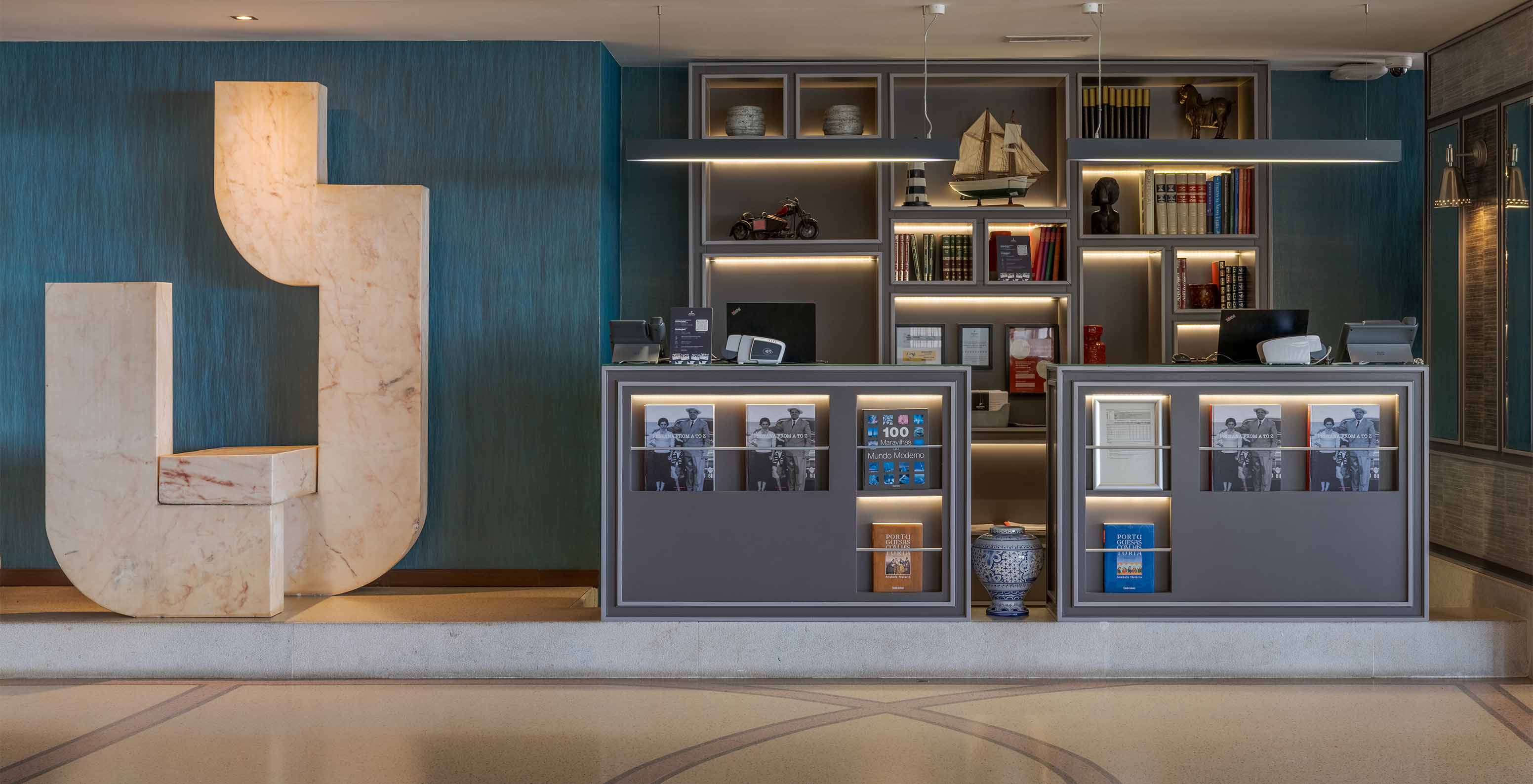 Reception with elegant decor, computers, and various books at Pestana Alvor Praia, Hotel with Spa and Pool