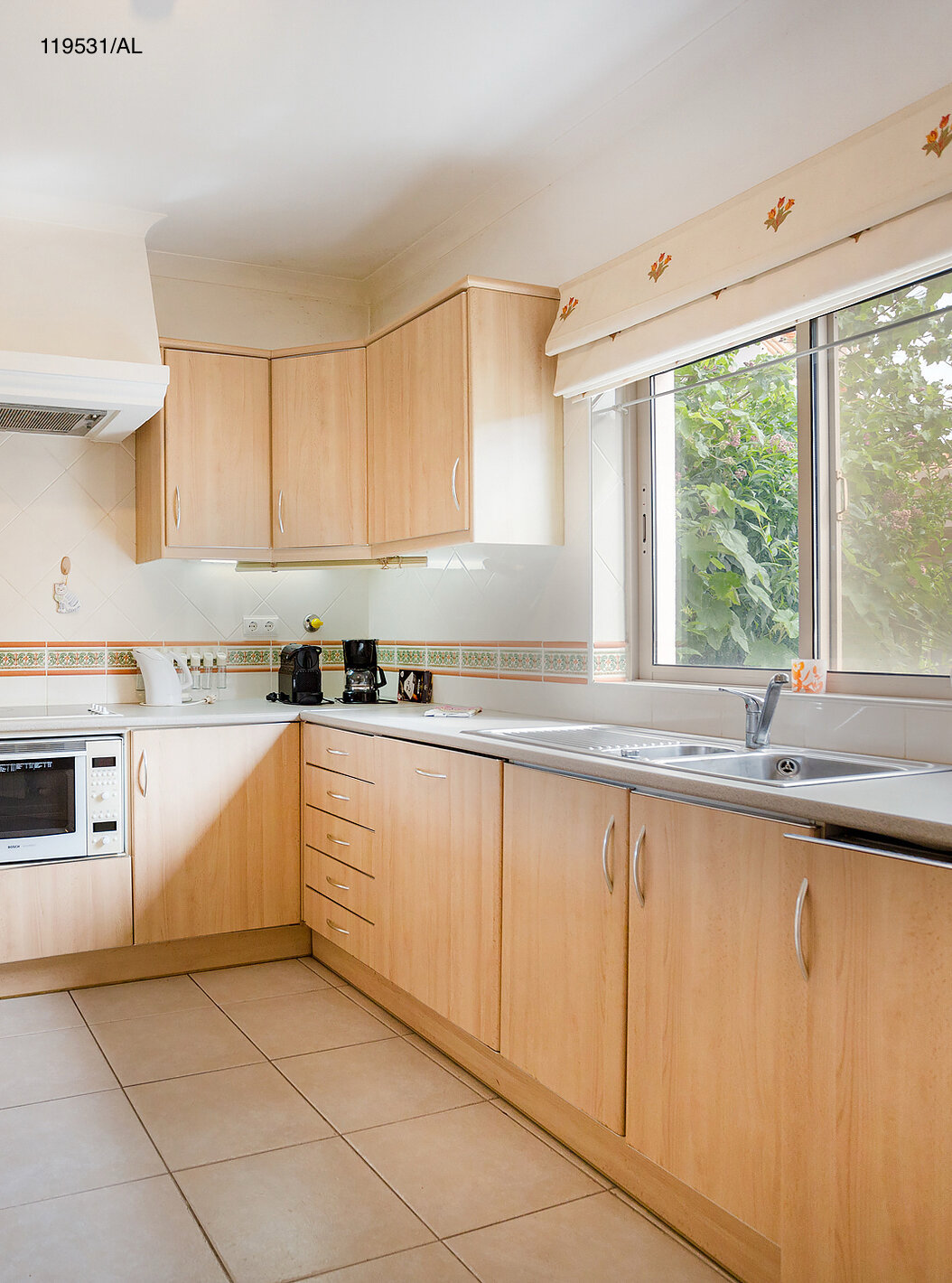 The Pestana Carvoeiro Golf T1 Standard Apartment has a kitchen equipped with wooden cabinets and appliances