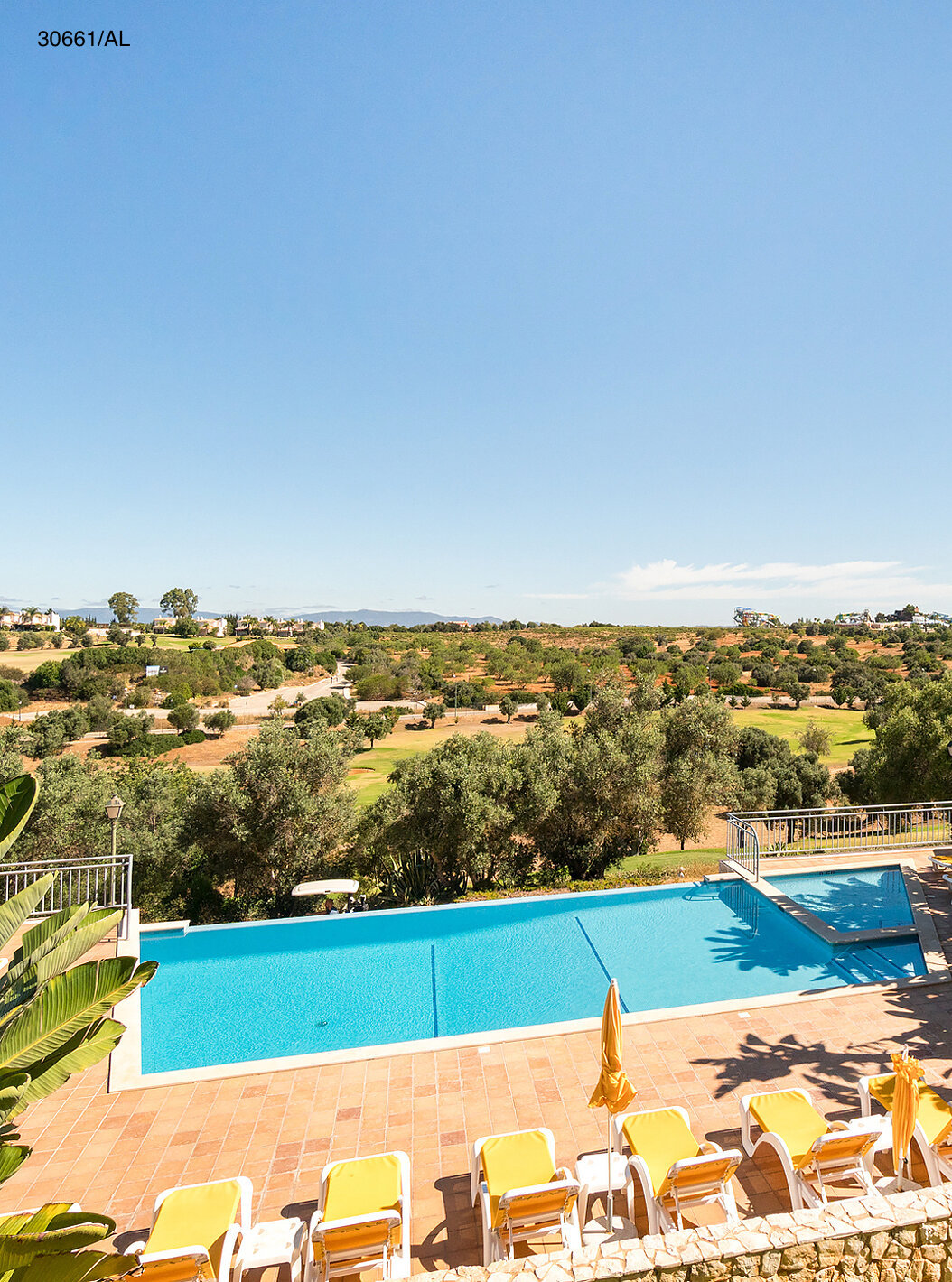The Pestana Carvoeiro Golf T1 Superior Apartment has an outdoor pool with yellow loungers around it