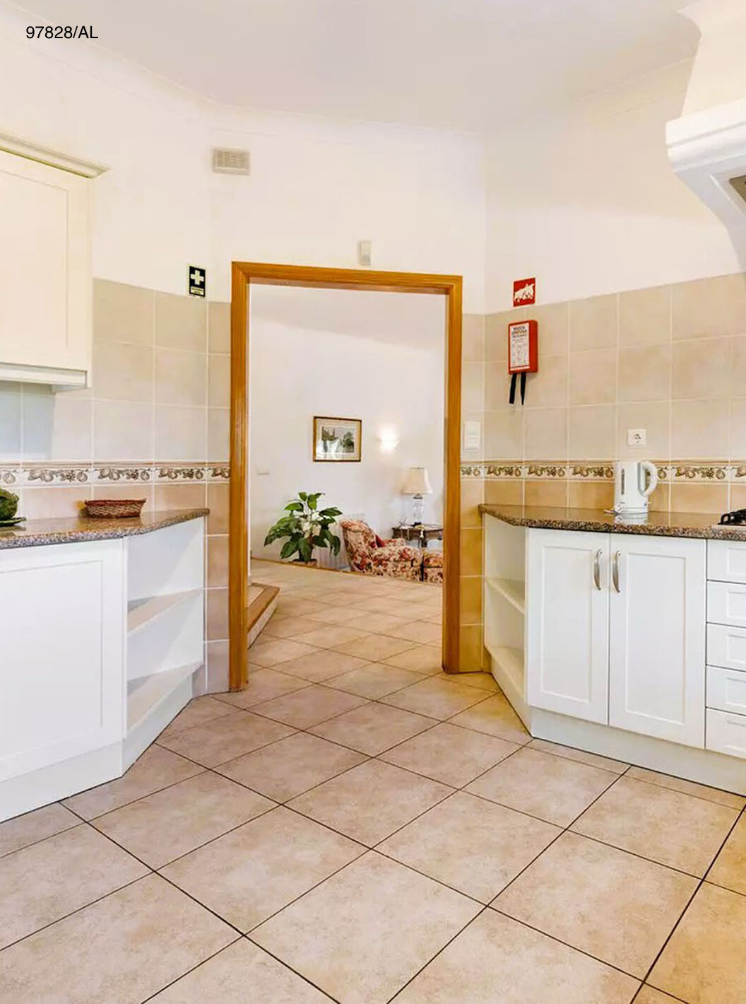 The Pestana Carvoeiro Golf V3 Standard Villa has a kitchen equipped with white cabinets and appliances