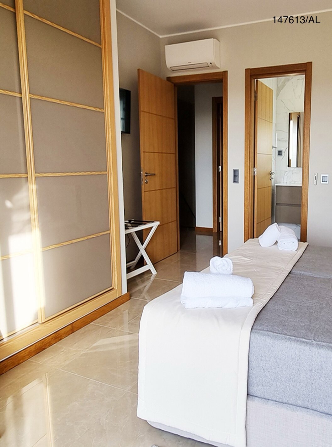 The Pestana Carvoeiro Golf V5 Superior Villa has a bedroom with two single beds, an armchair, and a nightstand