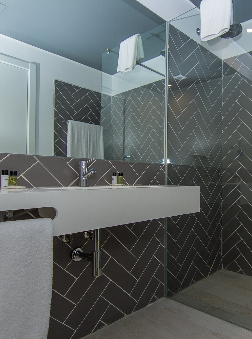 The Classic room at Pestana Gramacho Residences features a bathroom with a walk-in shower, sink, and mirror