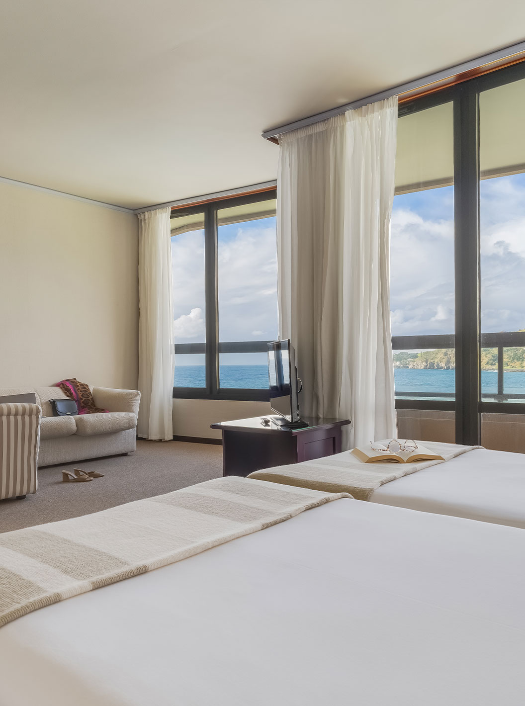 Junior Sea View Suite at Pestana Bahia Praia has a beautiful view of green landscapes and the sea, with access to the balcony