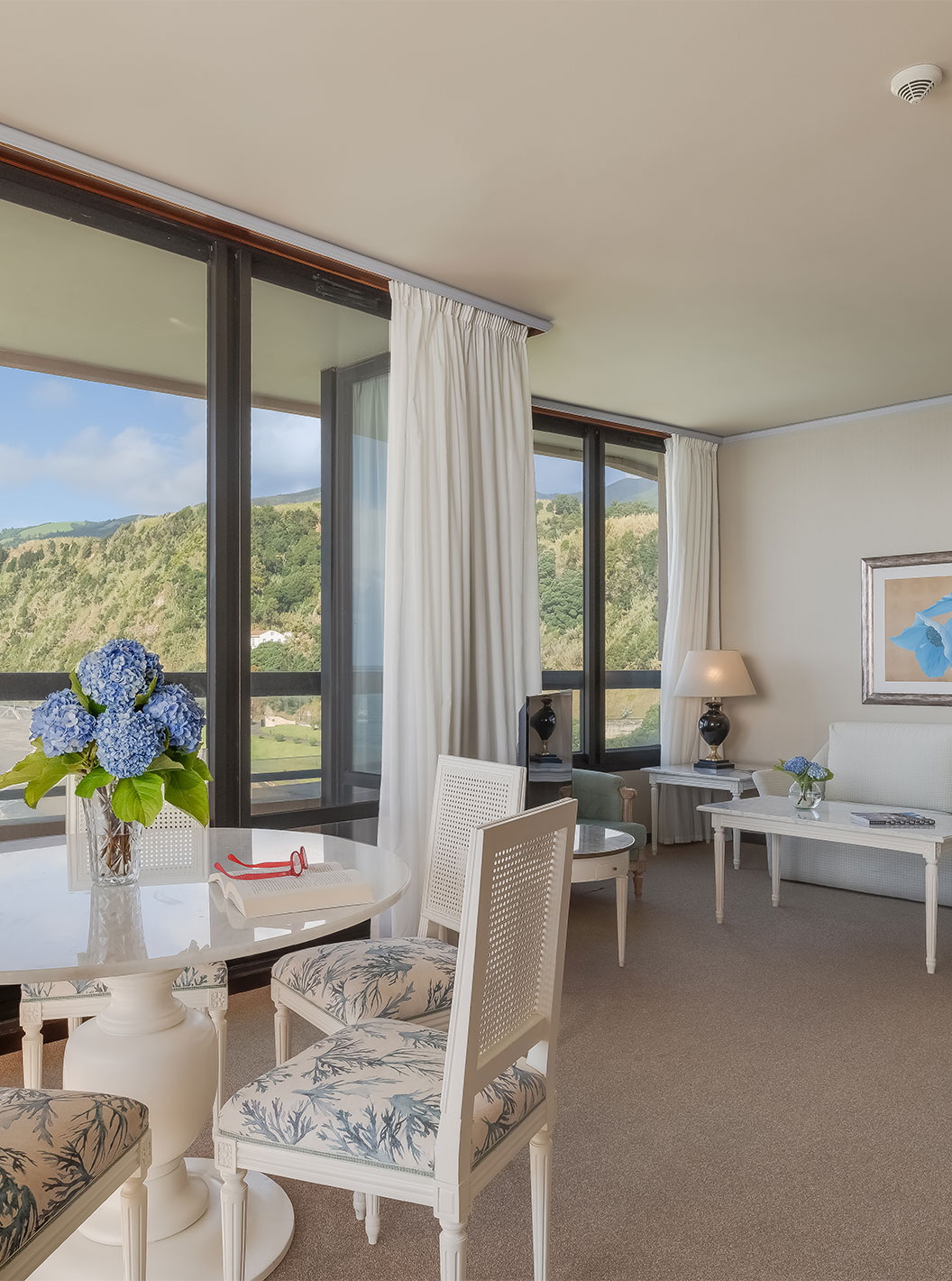 Suite at Pestana Bahia Praia has a room with a view of the beach next to the hotel and the green landscape