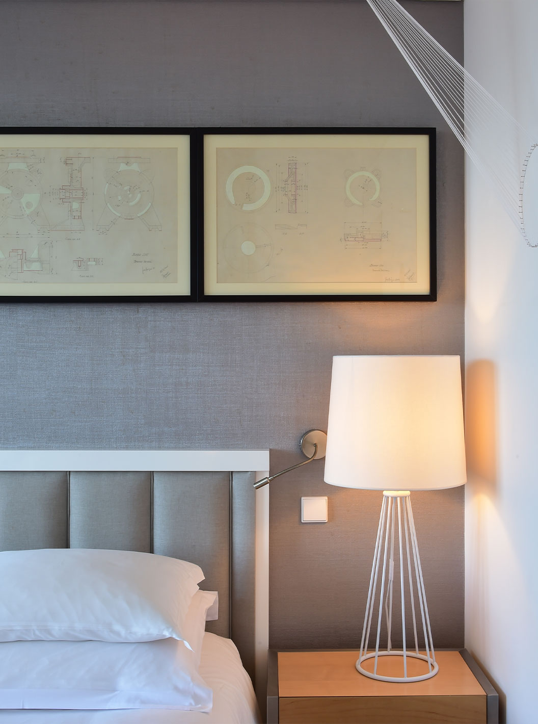 The Double Room Art District at Pestana Cidadela Cascais features an art wall, bedside table with a lamp, and paintings