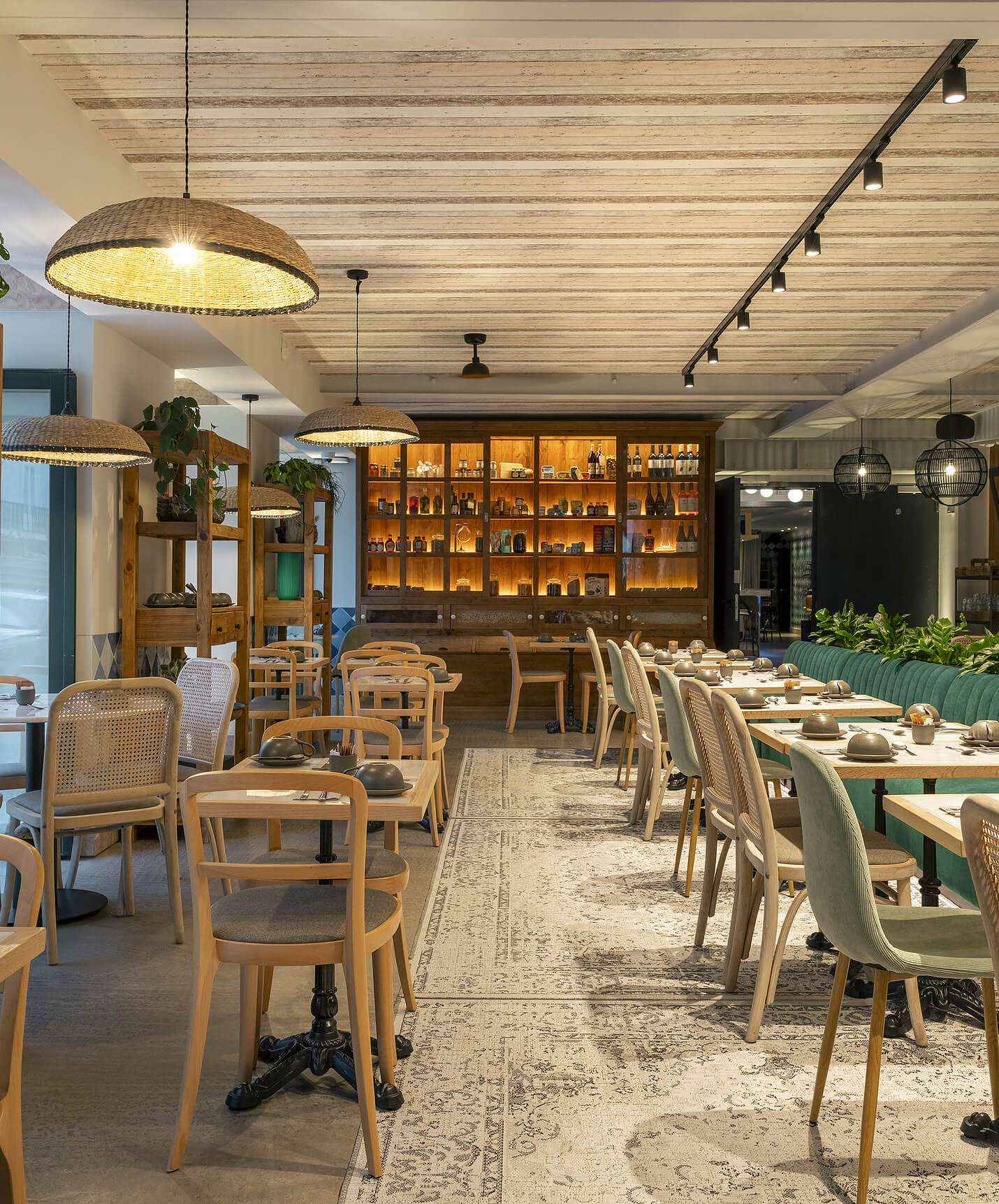 Olive restaurant at the hotel in downtown Lisbon has several tables, plants and modern decoration