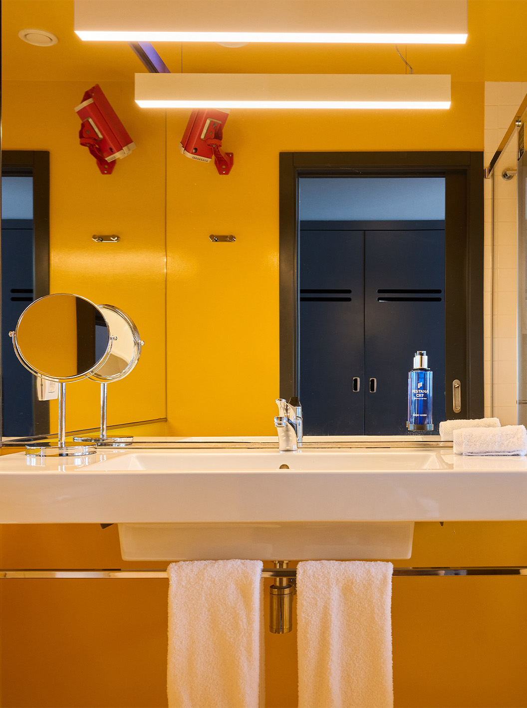 The CR Superior Room at Pestana CR7 Funchal has a modern yellow bathroom equipped with a shower