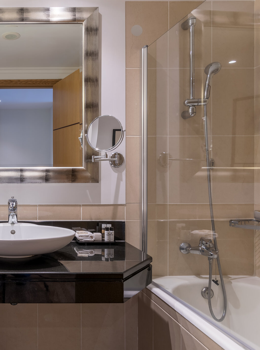 The Standard Suite Sea View at Pestana Grand has a bathroom with sink, bathtub with shower and towel