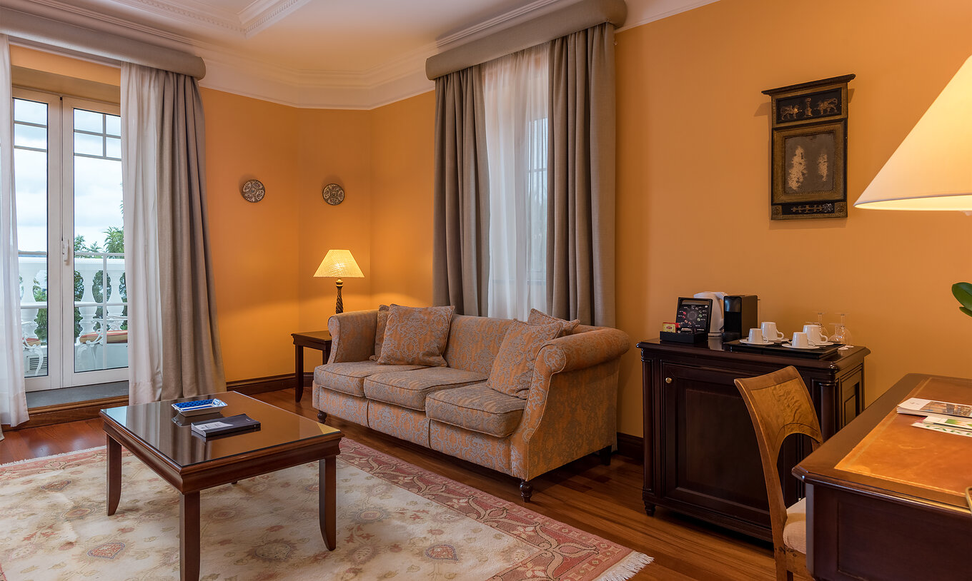 The Miramar Suite at Pestana Miramar has a seating area, with a sofa, coffee machine, kettle and a desk