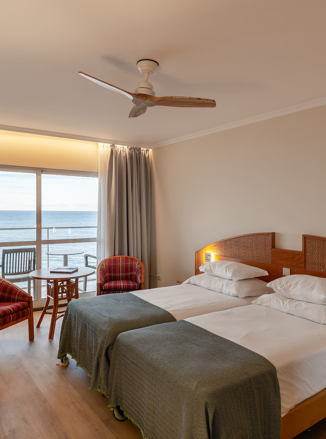 The Pestana Ocean Bay All Inclusive Superior Sea View has a double bed with a green bedspread and a balcony with sea view