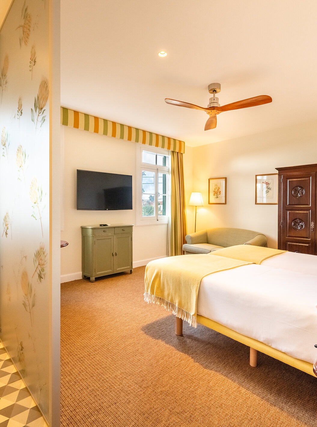 The Manor House - 1 of Pestana Quinta do Arco has two beds, wooden wardrobe, fan, and divider with the bathroom