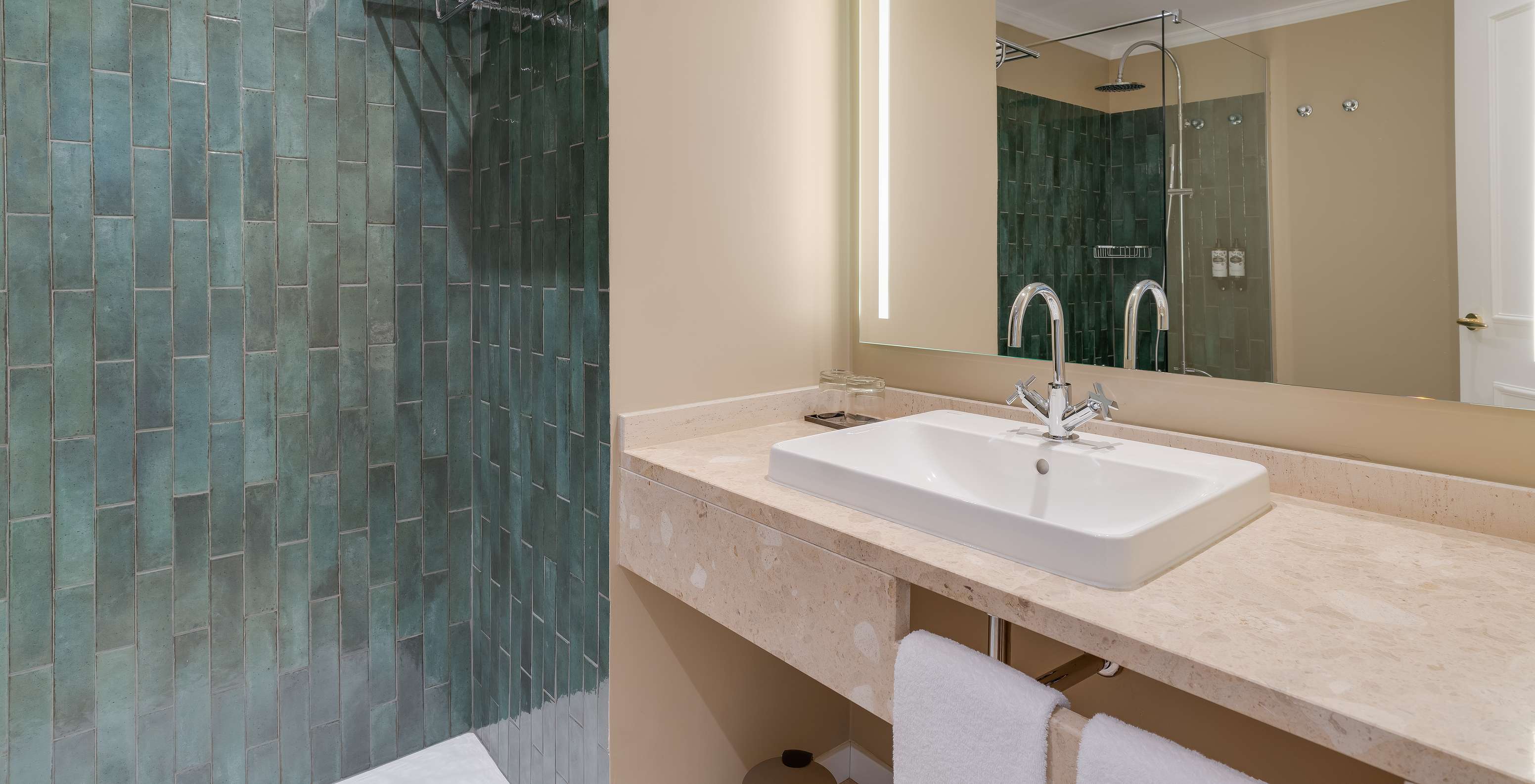 Classic room at Pestana Quinta Perestrello has a bathroom with sink, mirror, and shower