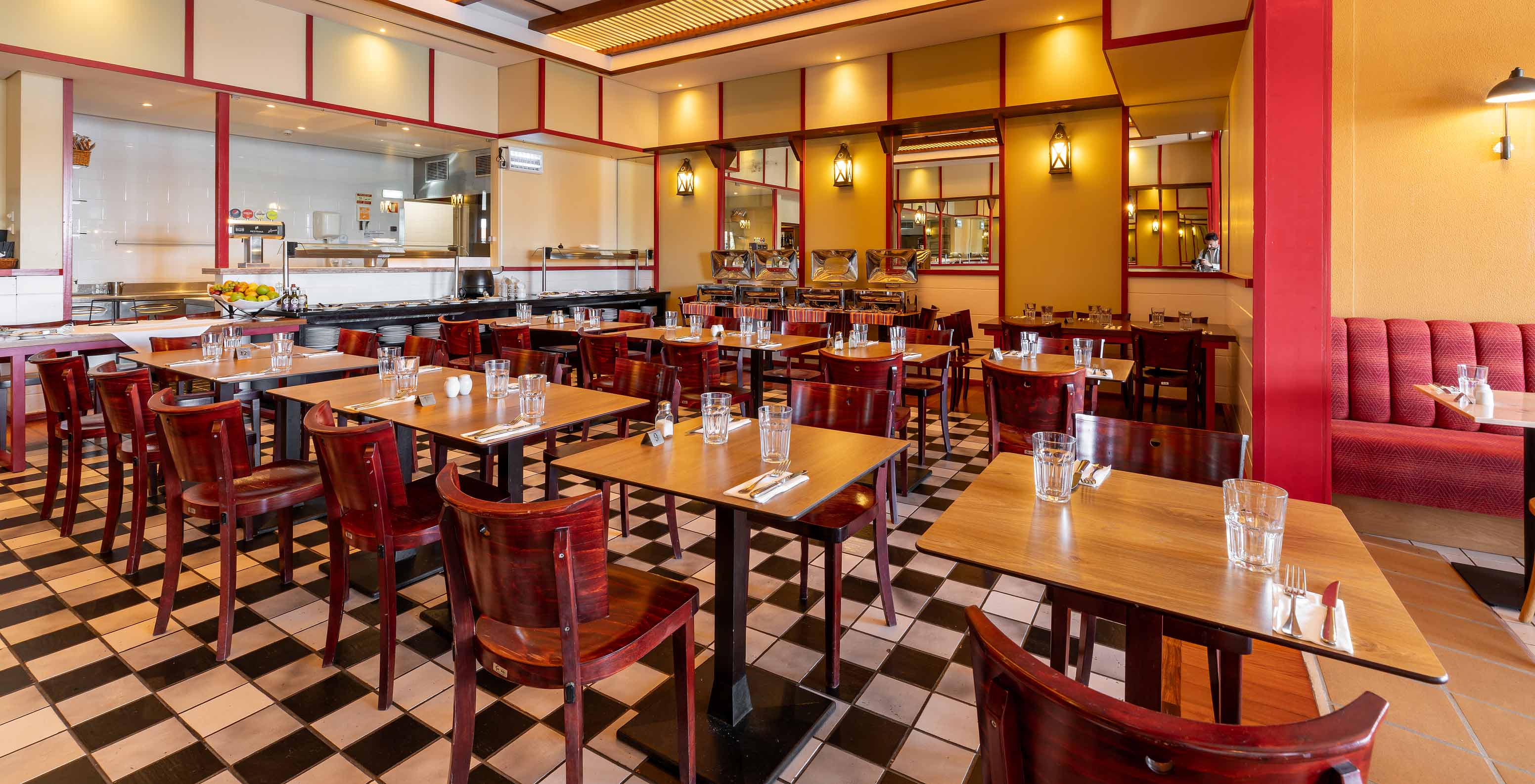 The Luigi restaurant at the 5-star Resort in Porto Santo has dark tables and chairs with red accents.