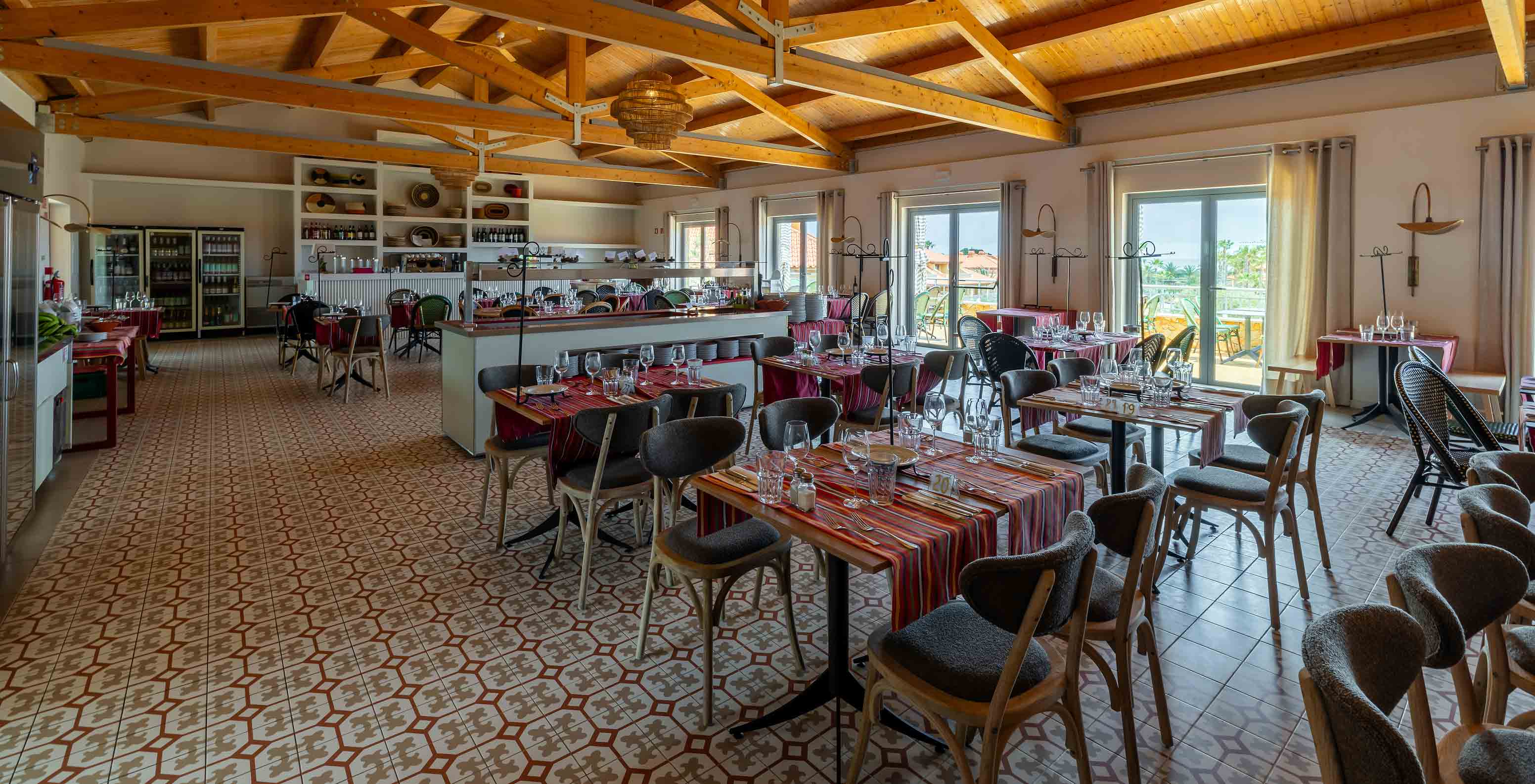 The Madeira Lovers restaurant at the 5-star Resort in Porto Santo has a spacious area with tiled floors.