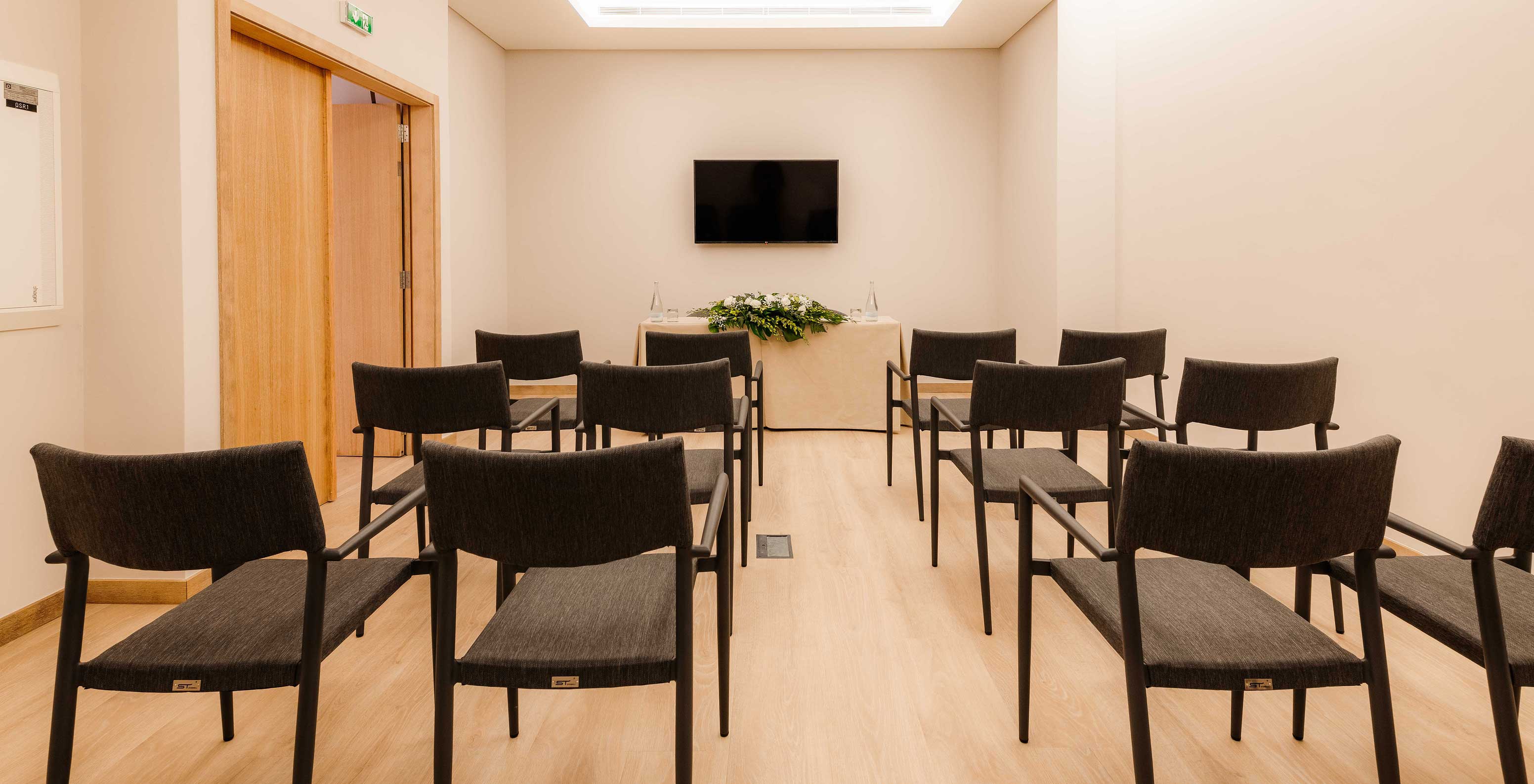 Douro VII room with chairs and a screen at Pestana Douro Riverside Hotel with Pool by the Douro River