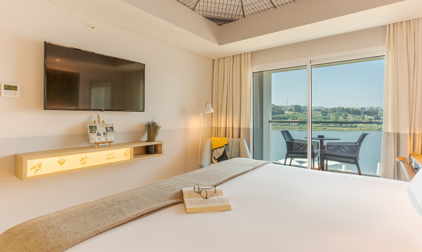 The Grand River View room at Pestana Douro Riverside features a bathroom with a sink, mirror, and shower