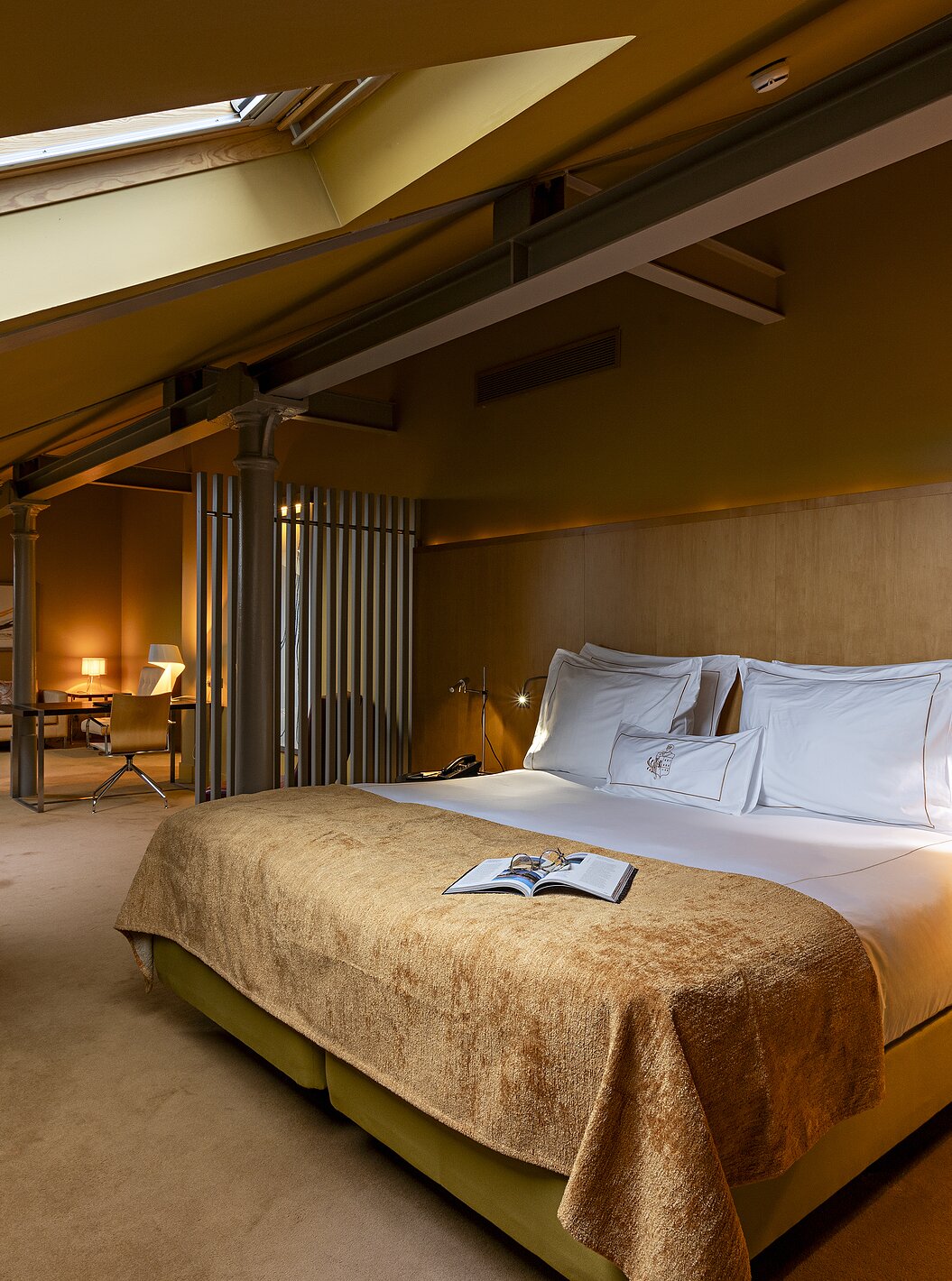 Pestana Palácio do Freixo’s Loft Attic is in the attic, with a double bed and yellow bedspread
