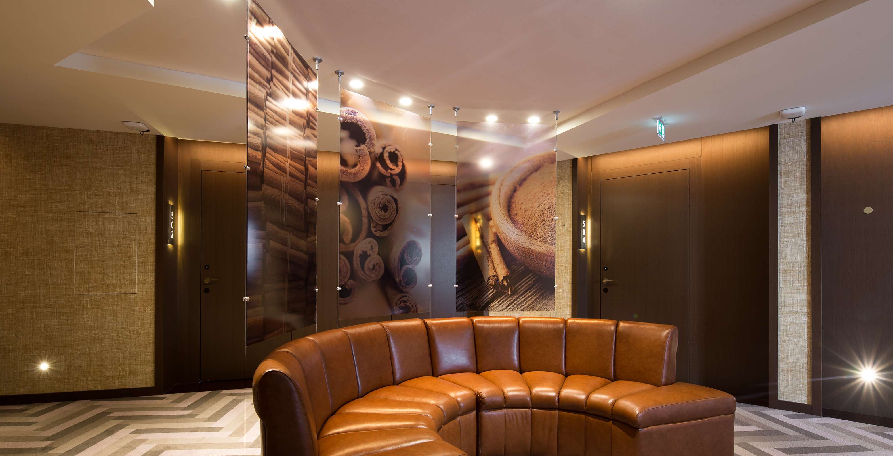 In the hallways to the rooms, there is a large brown sofa for guests to relax and photographs about the floor theme