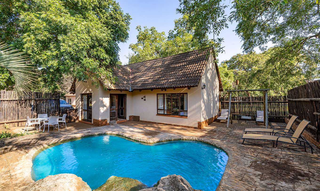 The Rhino Family Cottage at Pestana Kruger Lodge has a private pool with loungers by the room