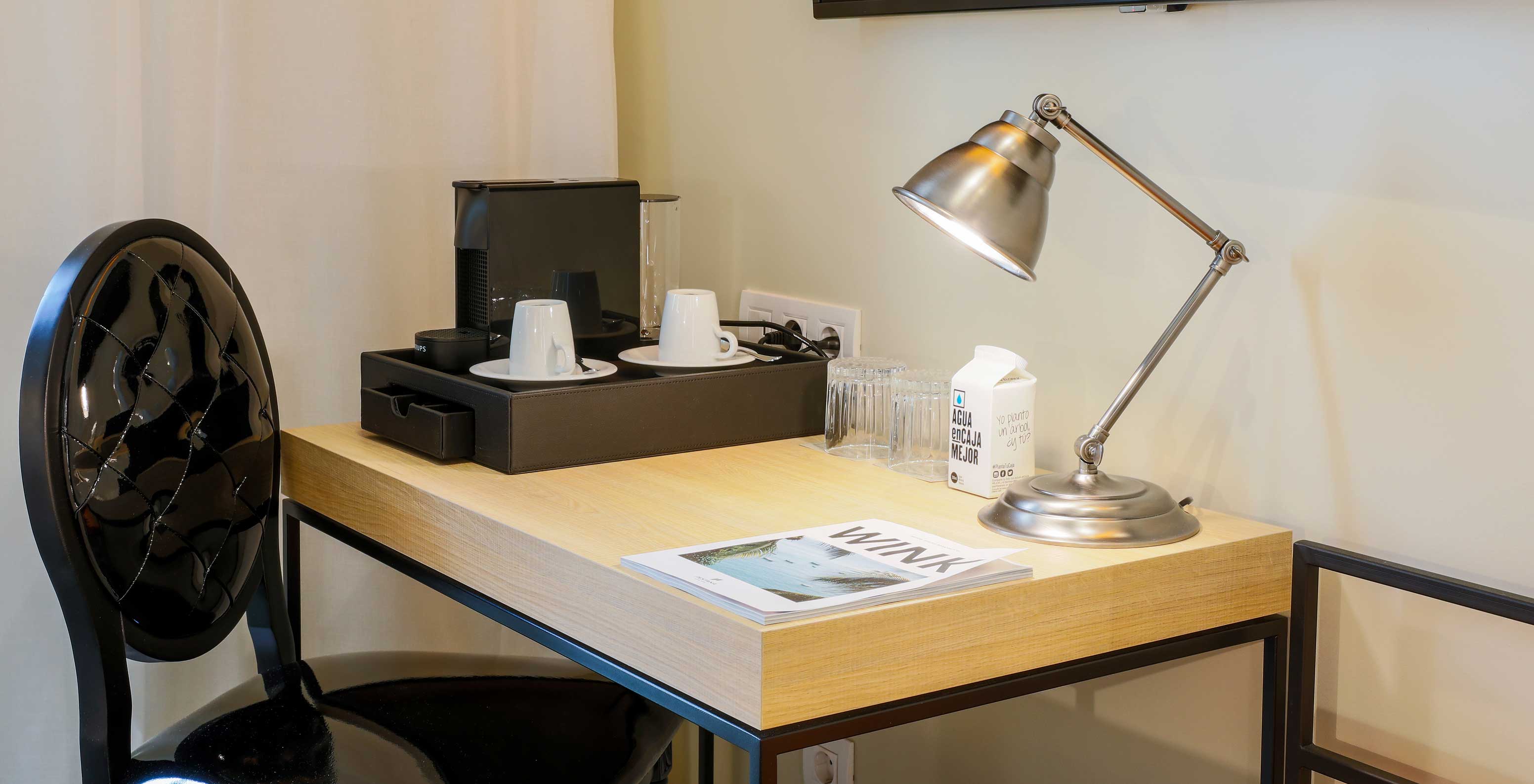 The Superior Plaza Mayor at Pestana Plaza Mayor Madrid has desk, chair, lamp, TV, coffee machine, cups