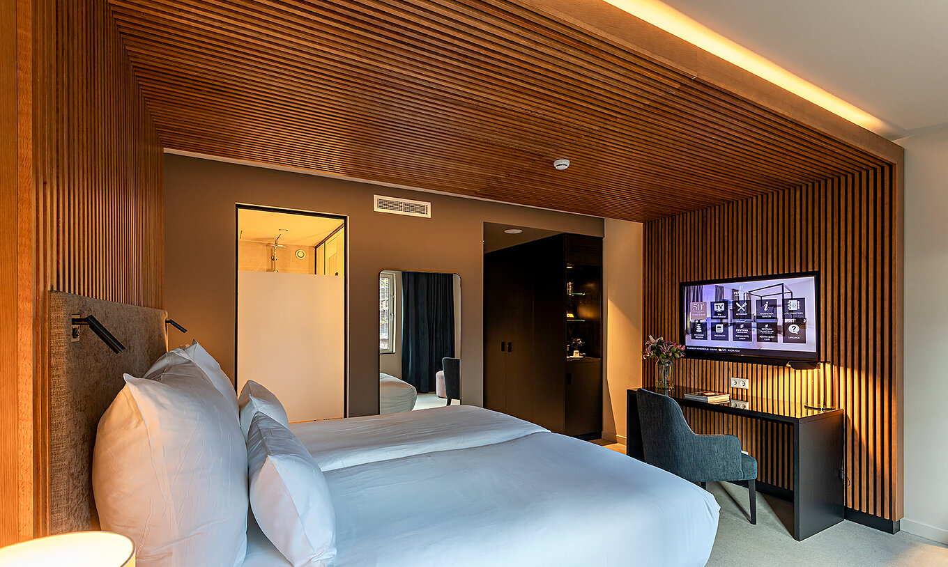Executive room at Pestana Amsterdam Riverside has two single beds, TV in front of the bed, and a desk
