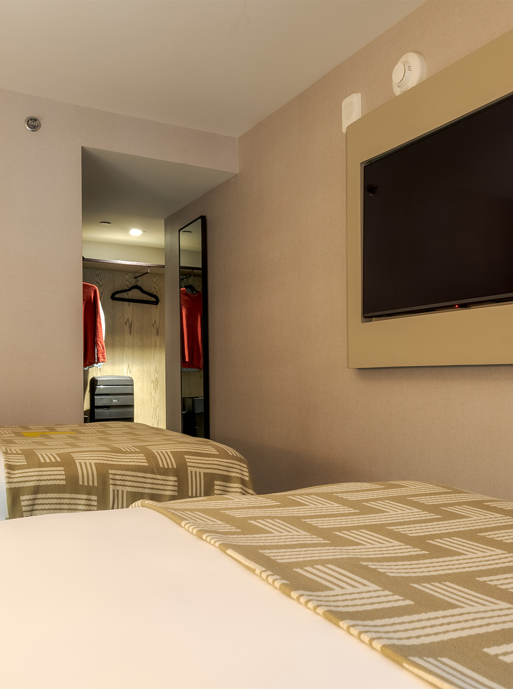The Comfort Double at Pestana CR7 Times Square has two beds with a bedspread with the number seven and a TV