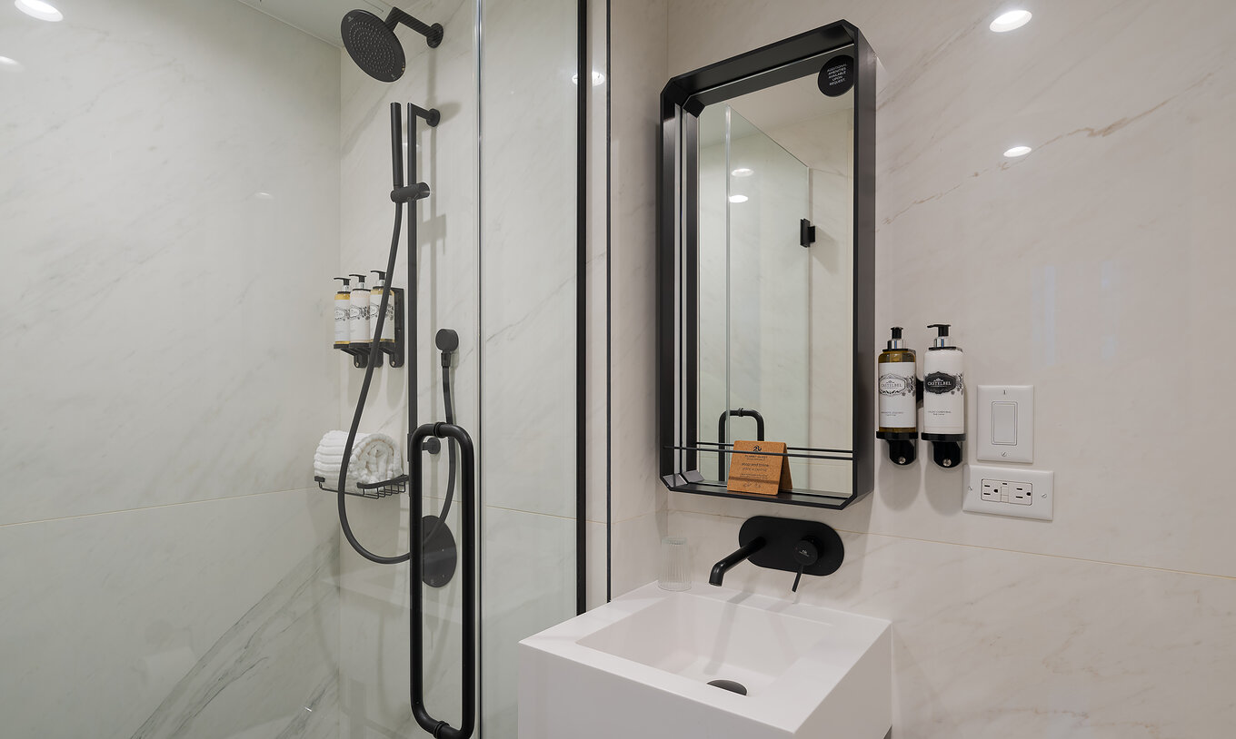 The Cabin room at Pestana Park Avenue has a bathroom with shower, sink and mirror