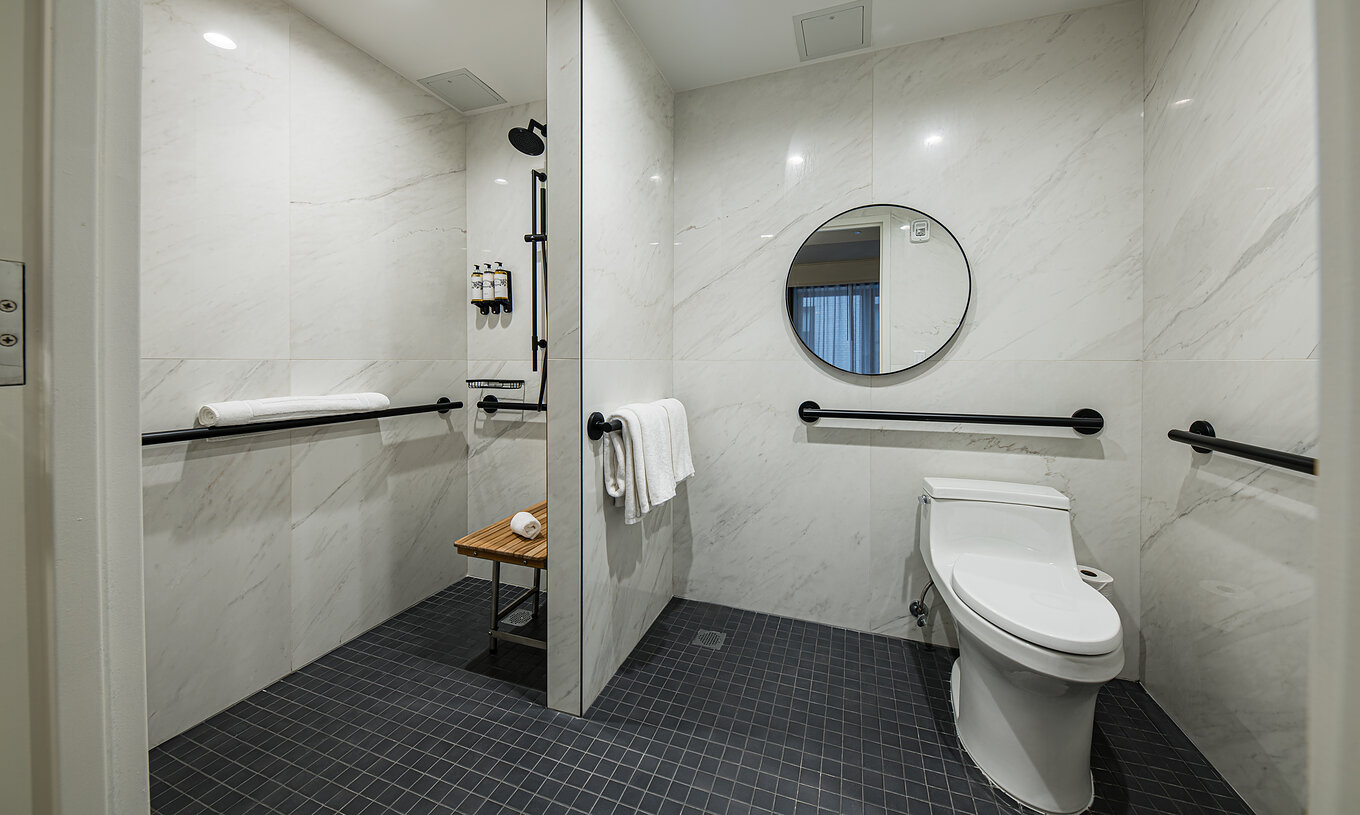 The Superior room - ADA at Pestana Park Avenue has an adapted bathroom with shower, mirror and toilet