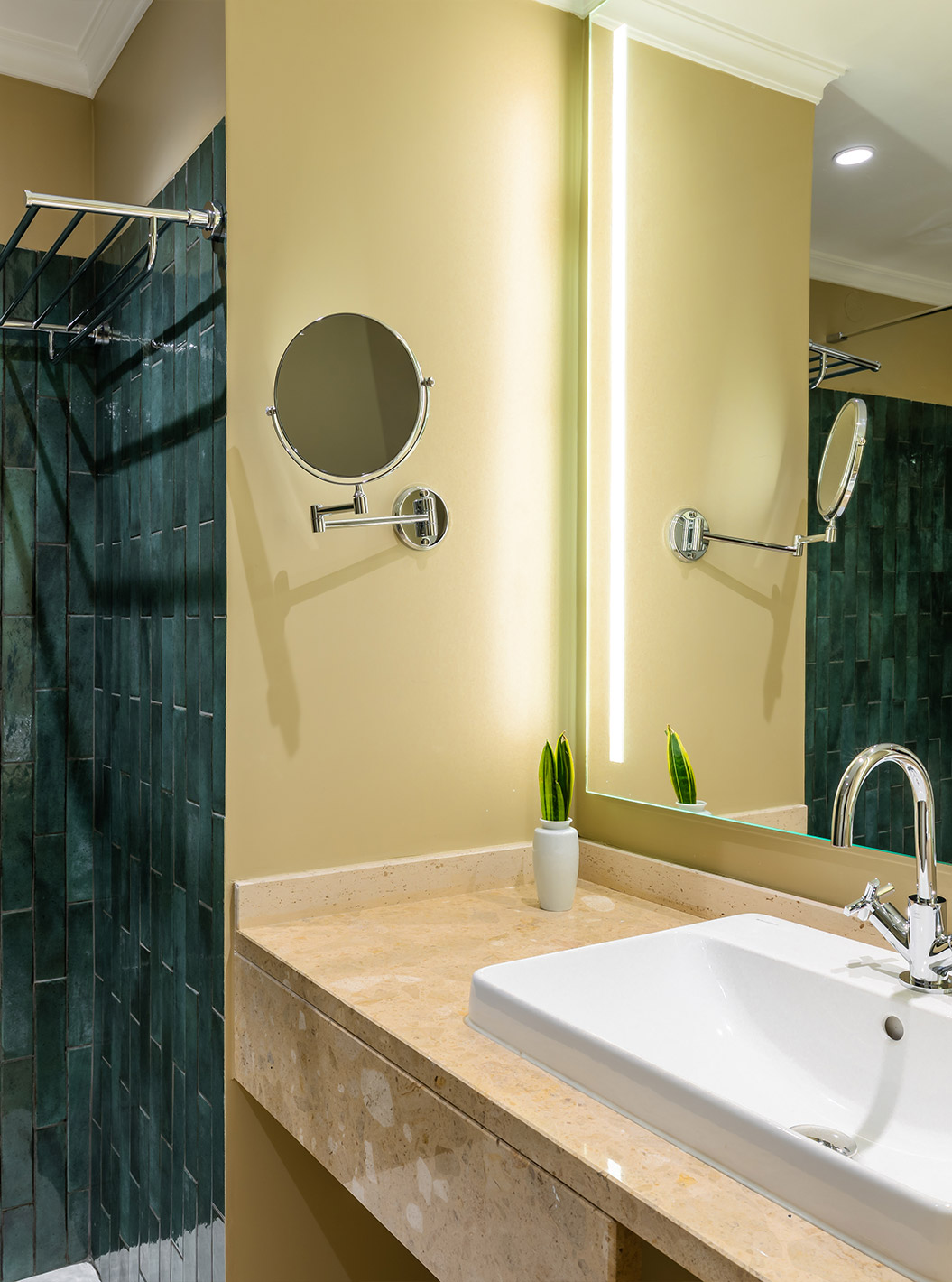 The Partial Sea View Room at Pestana Quinta Perestrello has a bathroom with a washbasin, mirror and green tiles.