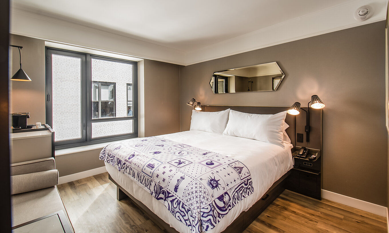 De Klassieke - ADA kamer van Pestana Park Avenue heeft een tweepersoonsbed, met nachttafel met lamp en telefoon