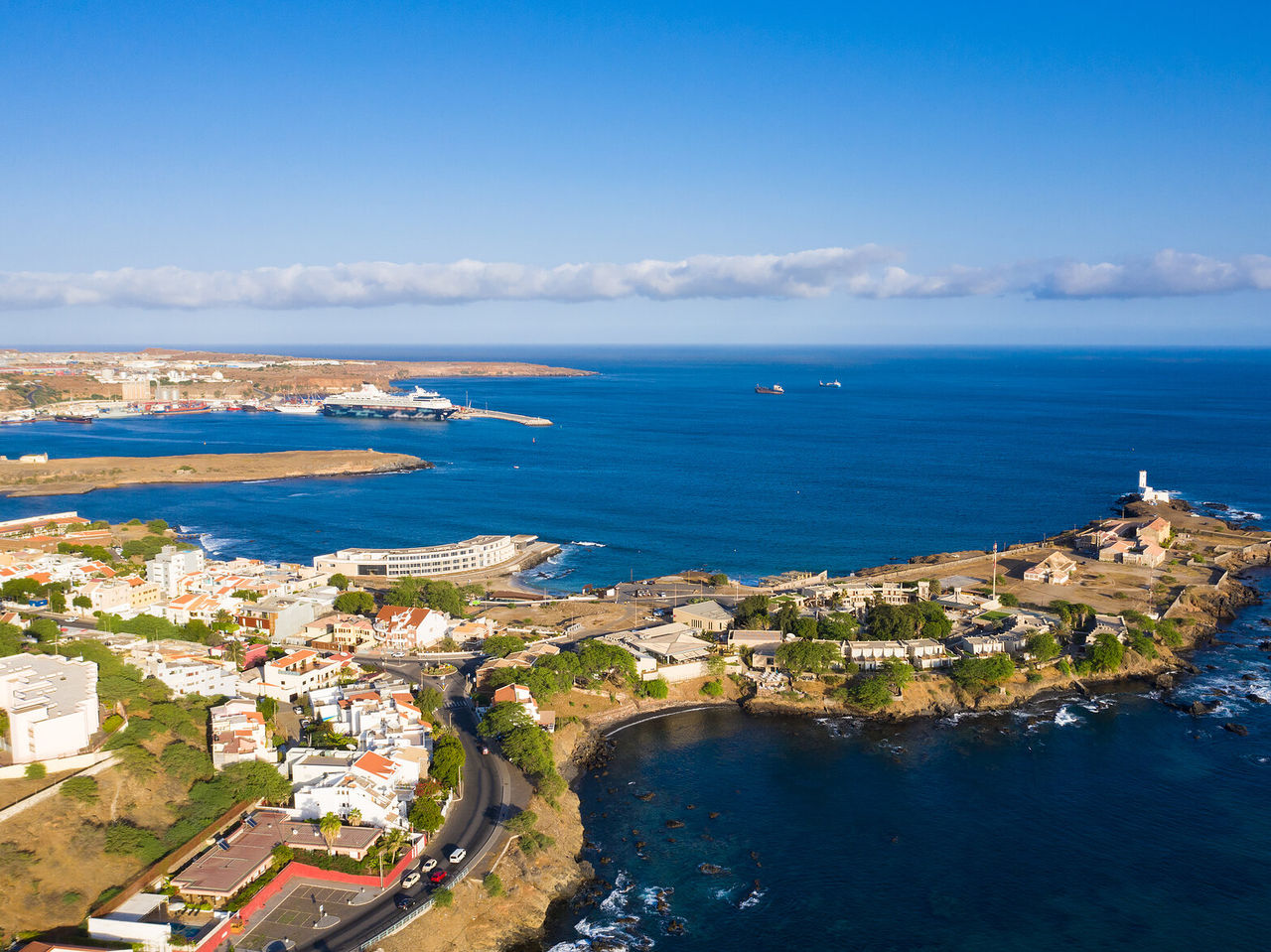 Aerial view of Praia in Cape Verde, showing the city stretching along the coast contrasting with the blue ocean