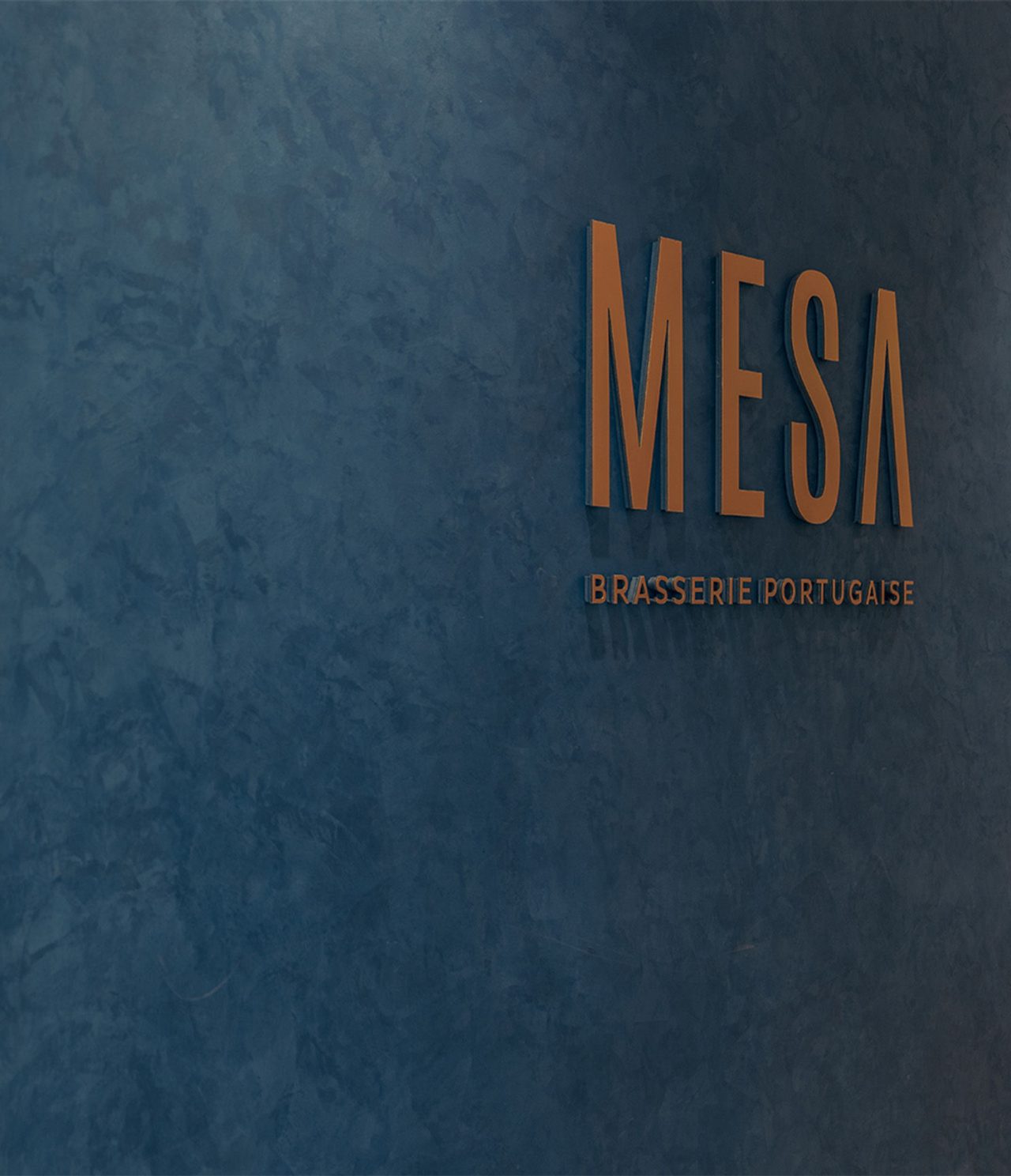 Brasserie restaurant, in a Hotel in Marrakech, features a blue wall with a logo