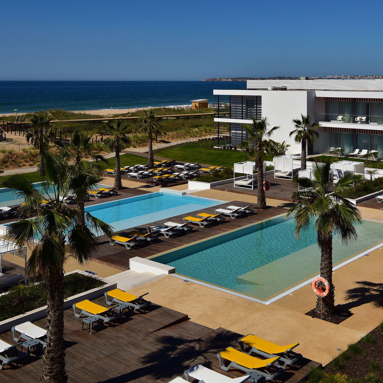 Aerial view of the pool at Pestana Alvor South Beach, a premium hotel near the beach, as seen in the image