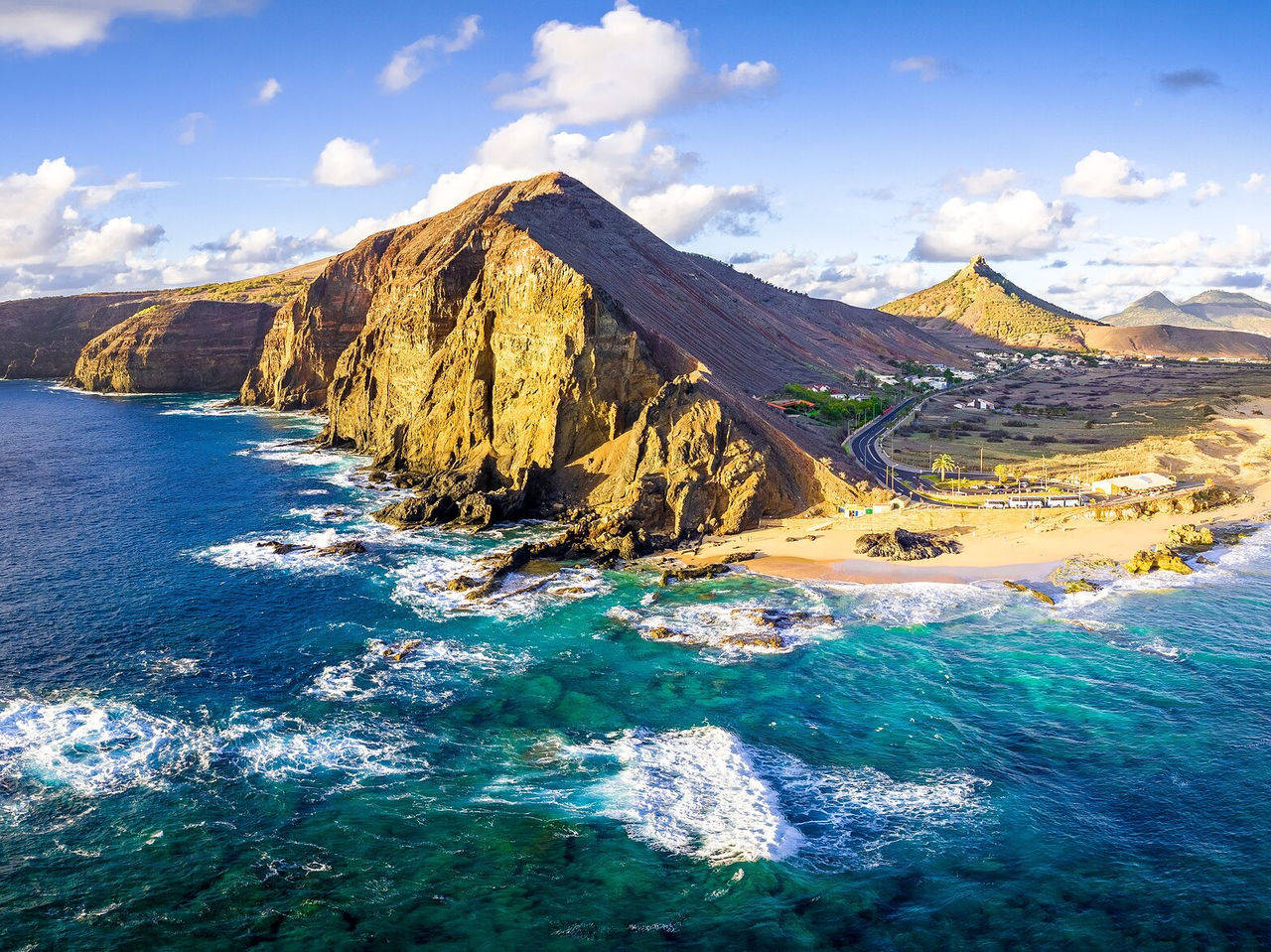 Lush coastal landscape of Porto Santo, with turquoise sea and golden sandy beaches