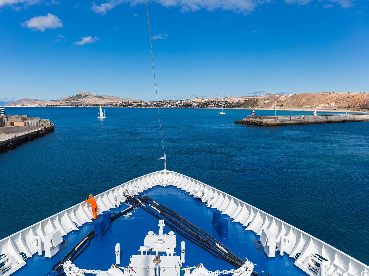 Bow of a ship overlooking the port of Porto Santo, with mountains and sea in the background