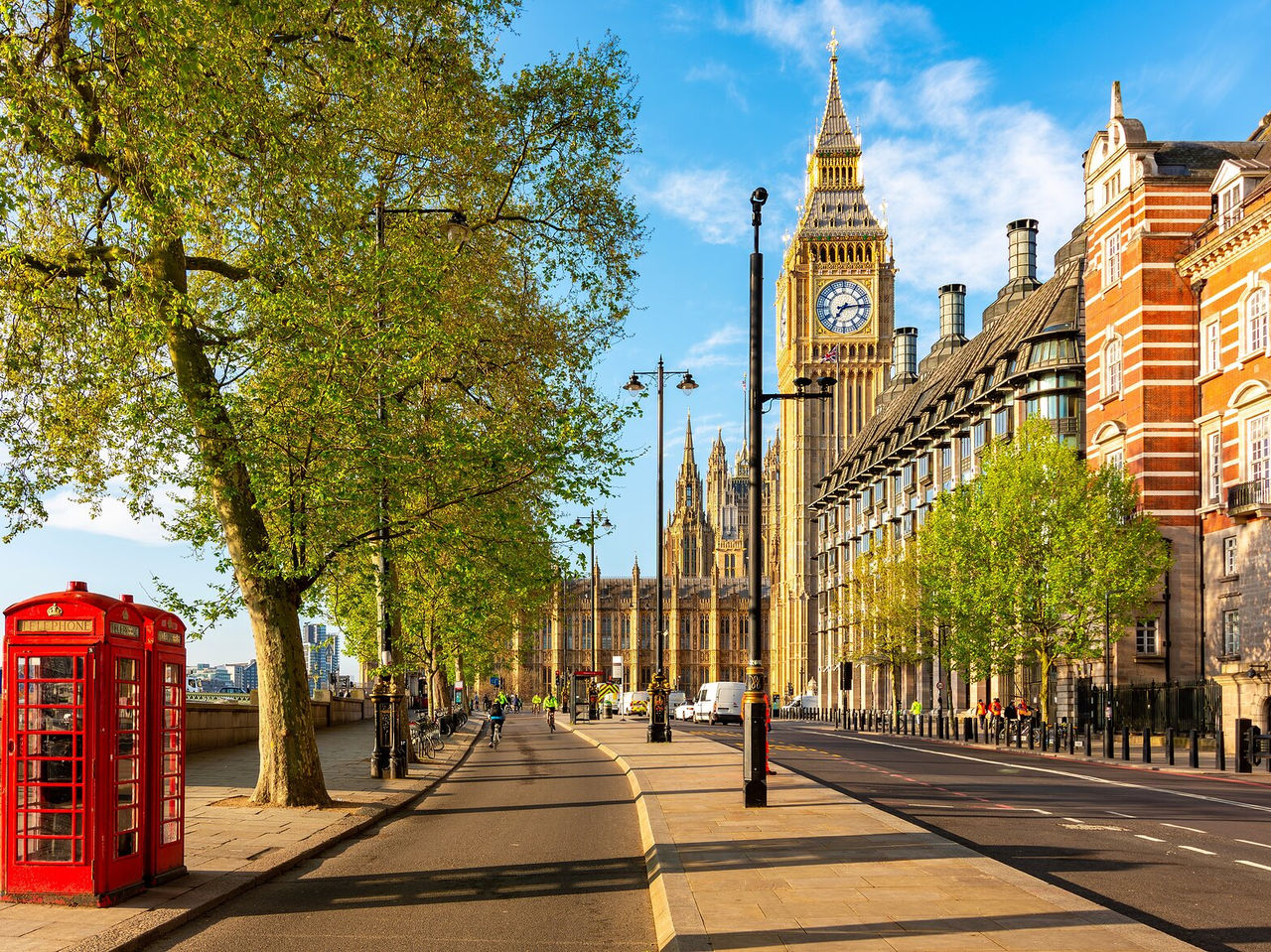 View from the Thames Riverbank in London, with Big Ben and the Palace of Westminster in the background, and a telephone booth