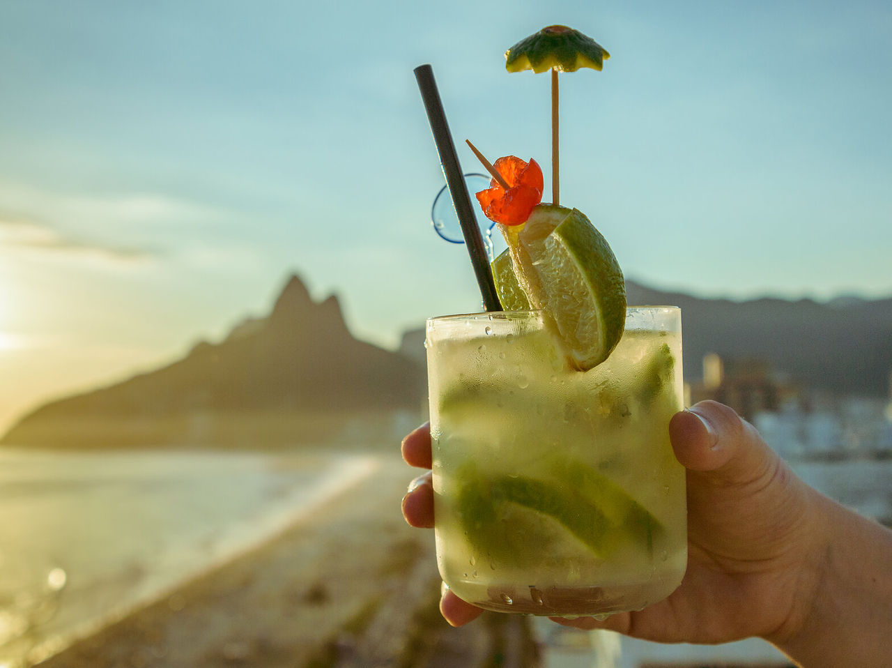 Typical caipirinha from Rio de Janeiro with Ipanema beach and the Dois Irmãos hill in the background